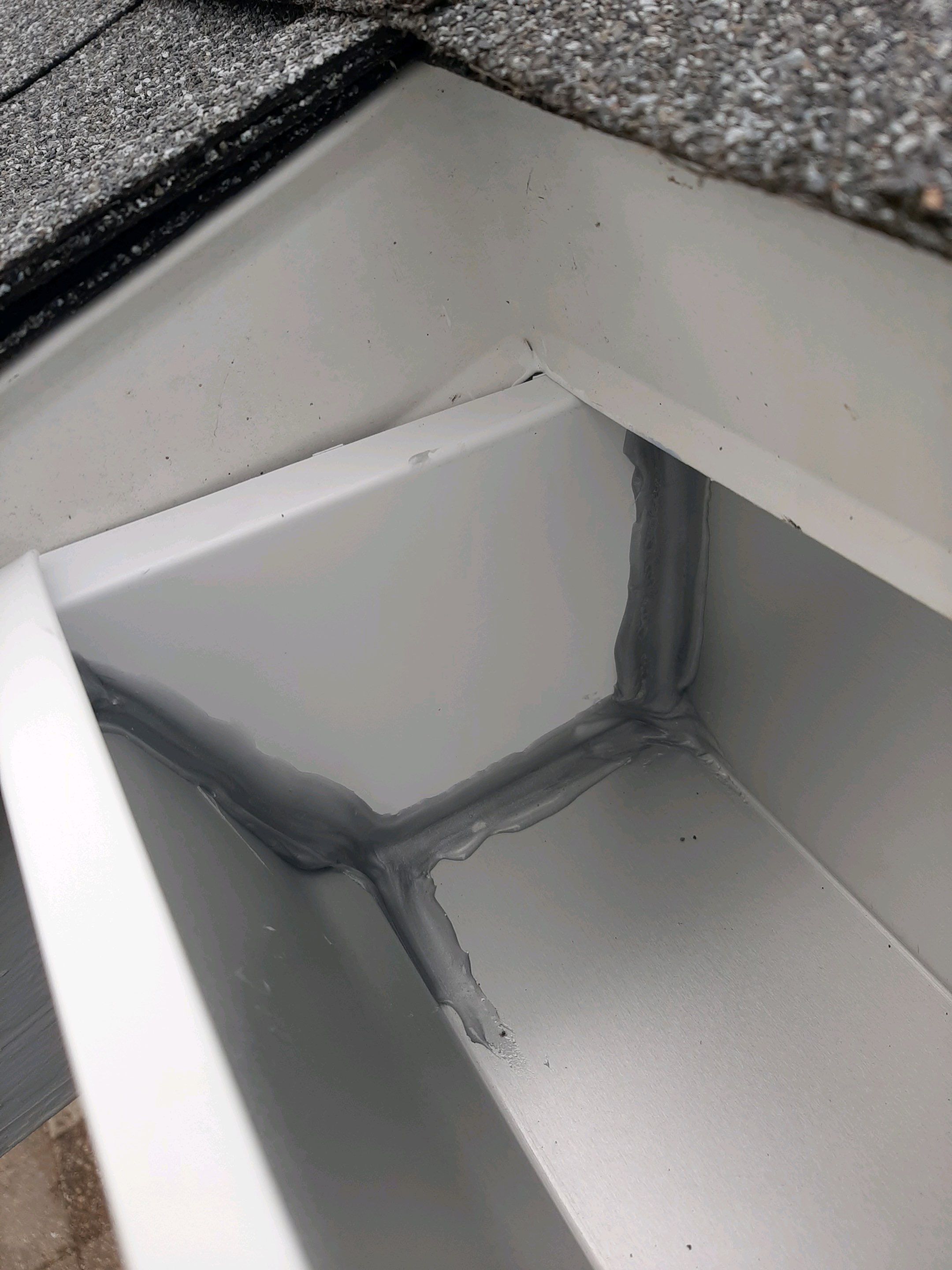 Gutter Installation using White Seamless Gutters by Gutter Professors