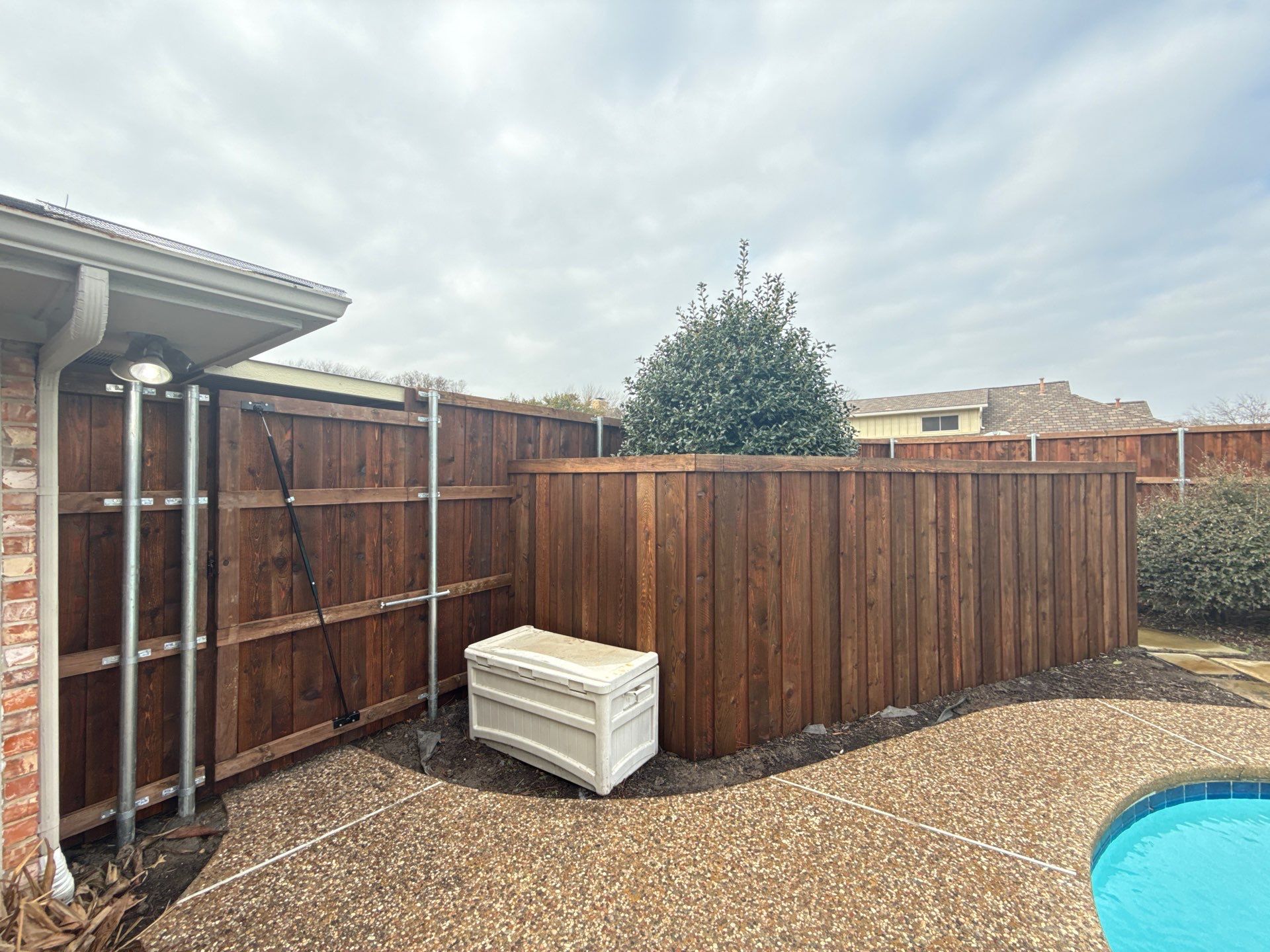 Pre-Stained board on board w/ trim and kickboard using 1x4 cedar trim by Grizzly Fence And Patio
