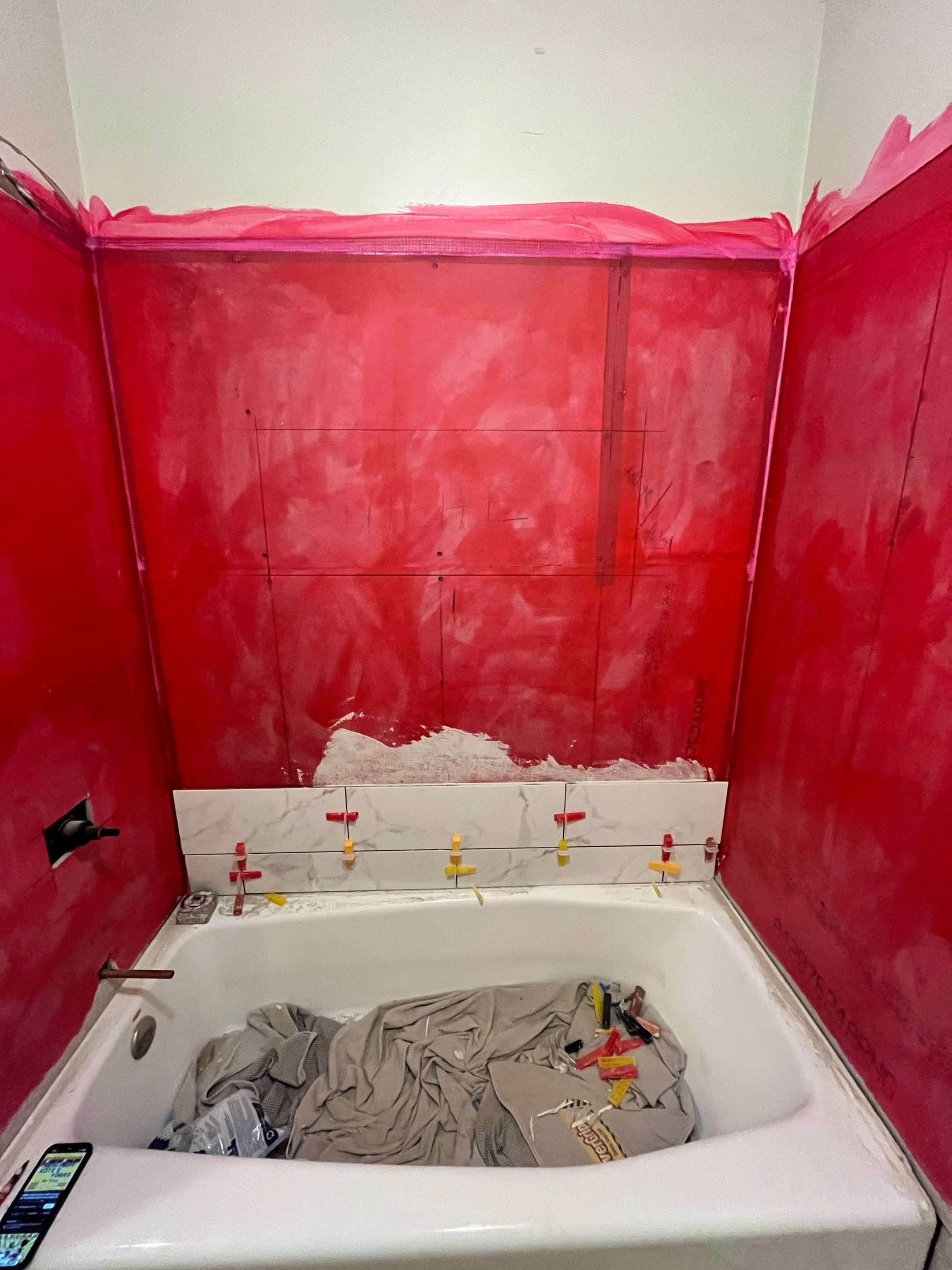 Tub retile, floor, vanities, mirror, and lights by Prudencio