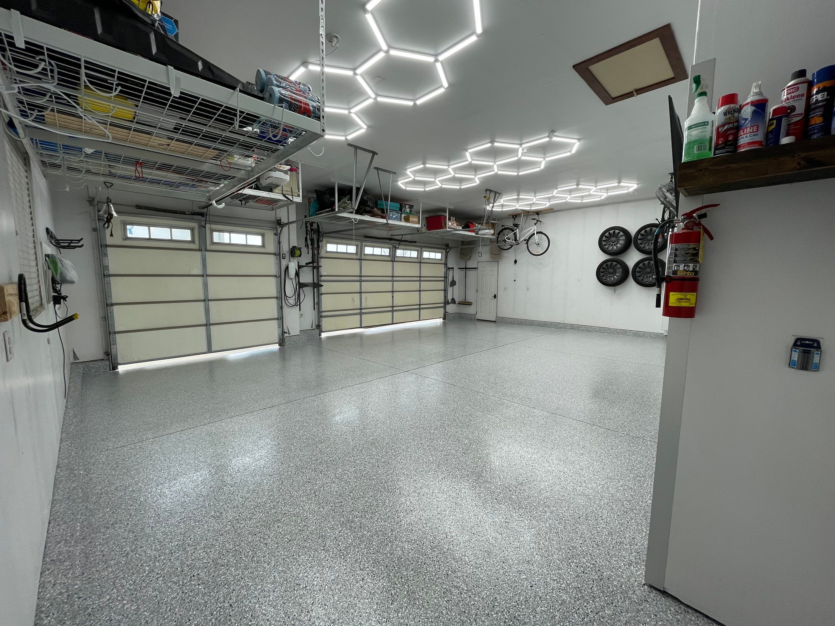 Feather Gray Epoxy Floor Coating Installation in Sioux Falls by Select Painting, Coatings & Garage Cabinets