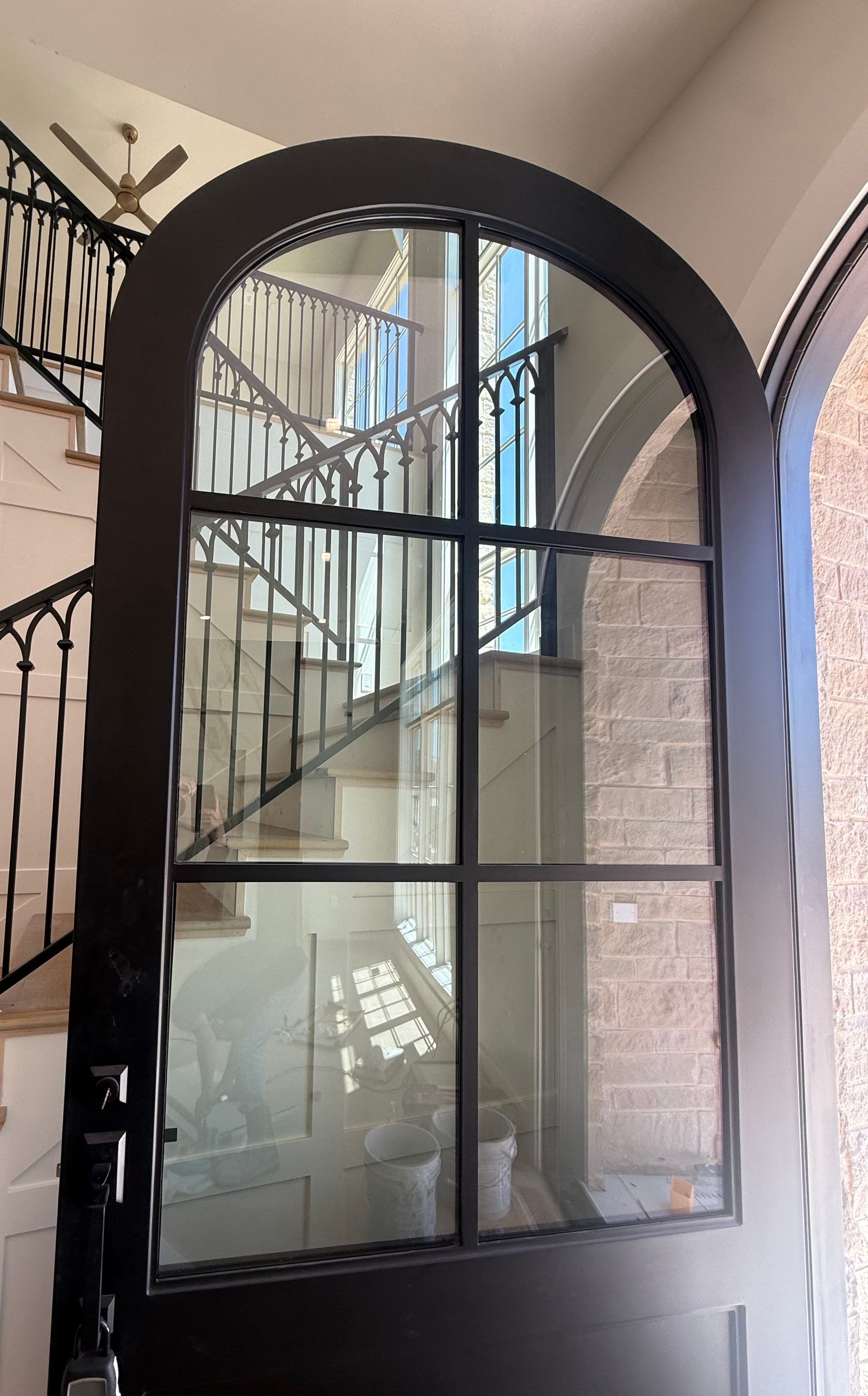 Custom Black Metal Arched Entry Door Installation in Southlake by Solara Custom Living