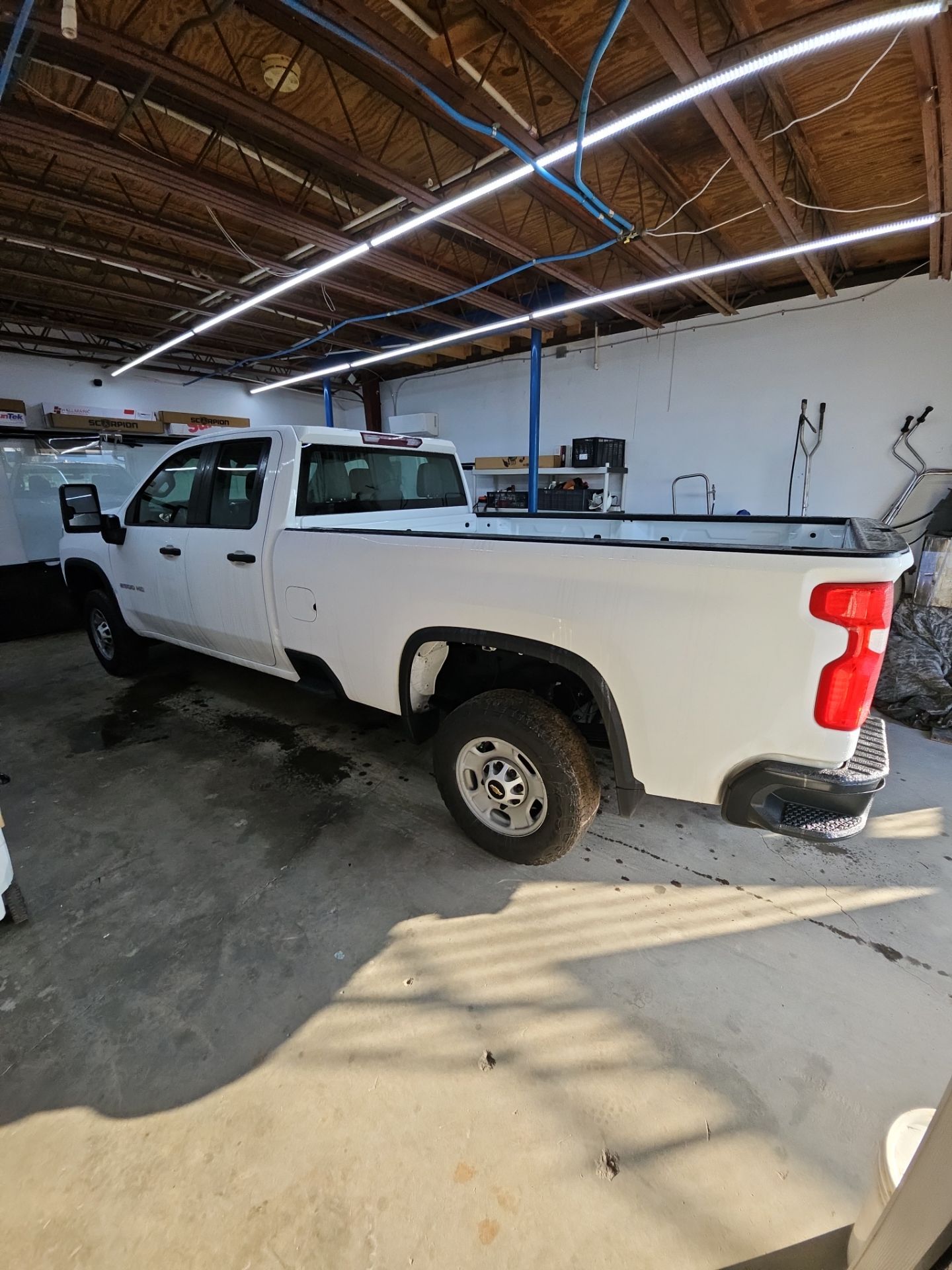 the service being done is likely the application of window tints on the truck this involves preparing the windows cleaning them and applying the tint film to reduce glare and heat while enhancing privacy the truck appears to be a work vehicle suggesting the tint service may be aimed at improving comfort for the driver and passengers during long hours on the road