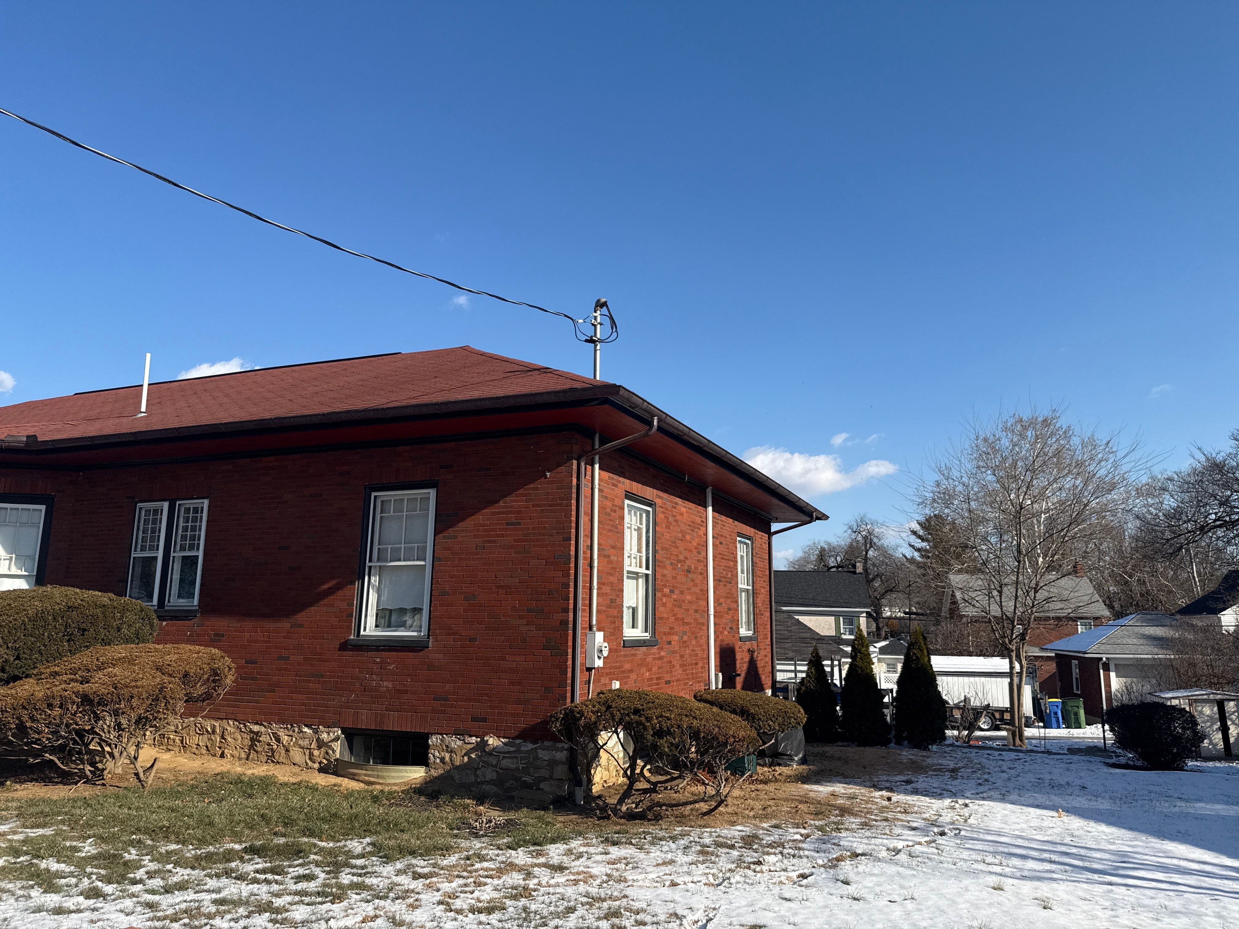 Red Metal Roofing Upgrade for Brick Home by Esh Builders