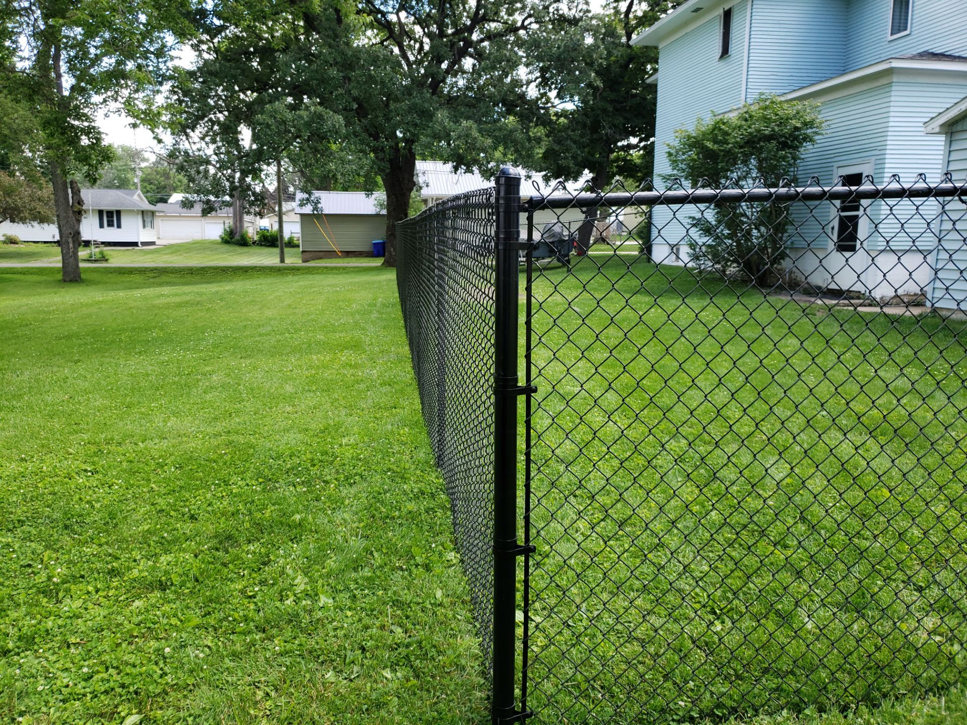 Black Vinyl Coated Chain Link Fence Installation in Independence by Perfect Picket Fence and Stain