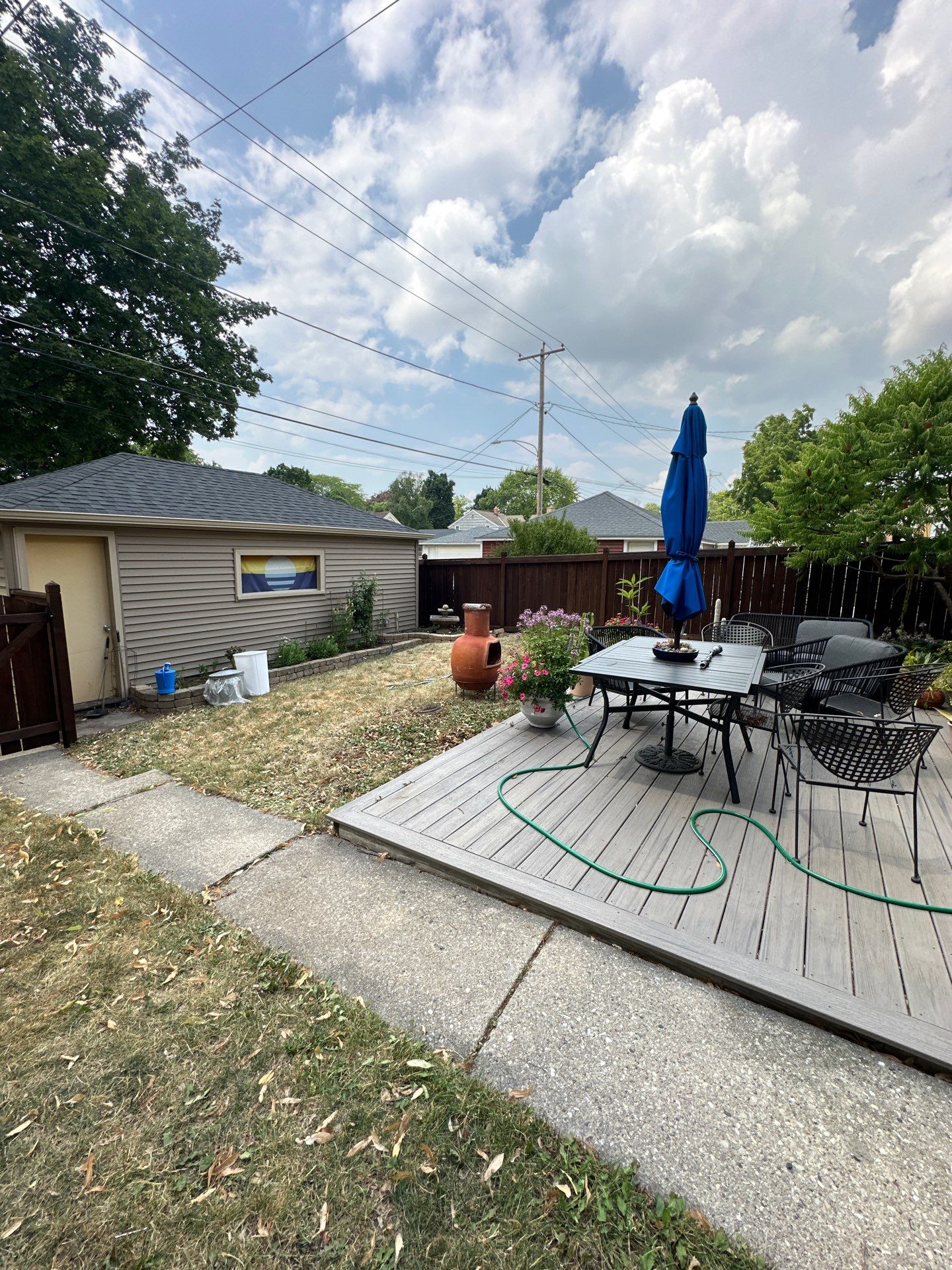 Dark Stained Privacy Fence and Composite Deck in Milwaukee by OCS Contracting Services