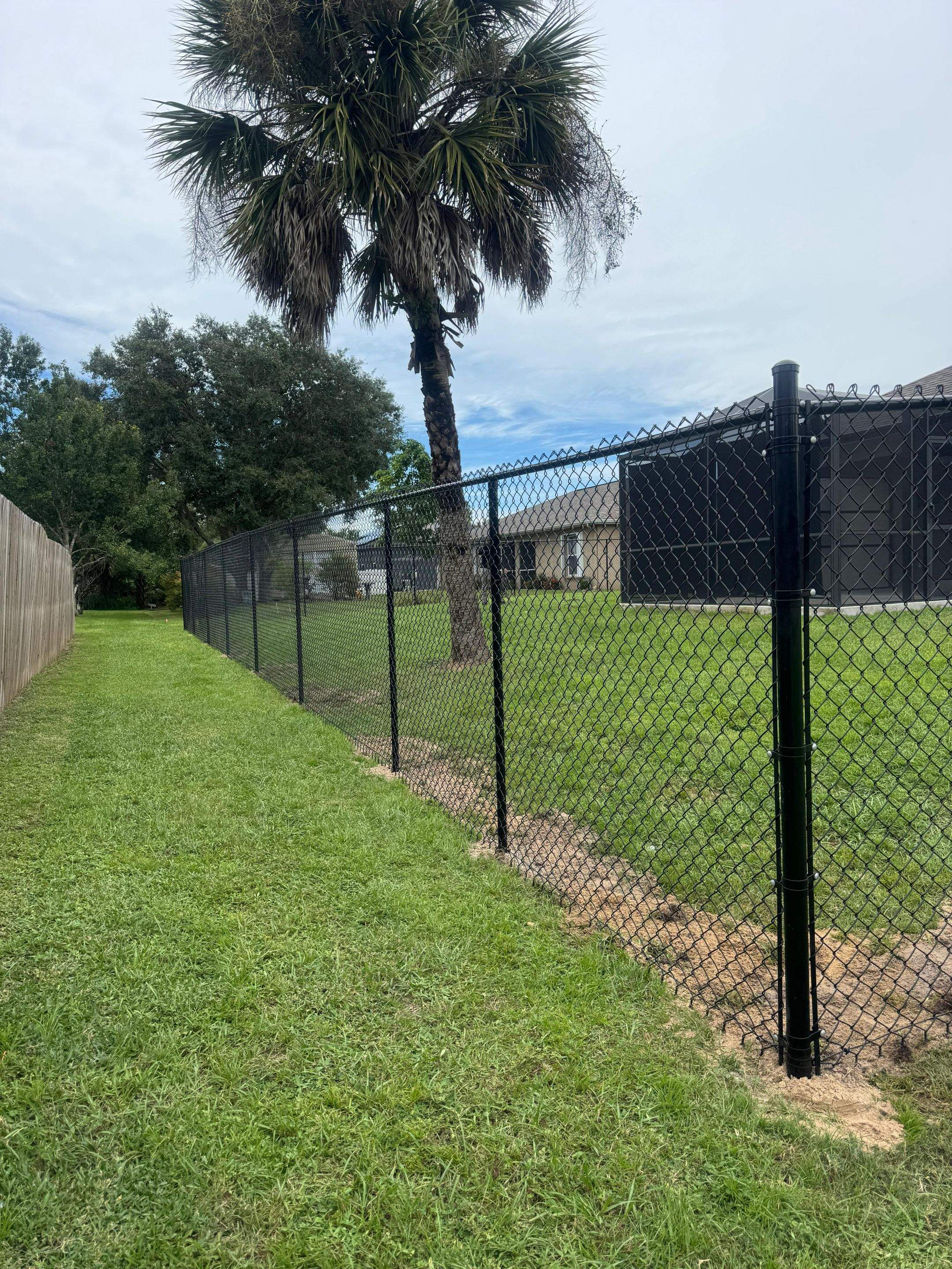 Black Chain Link Boundary Fence with Access Gates in North Port by True Fence LLC