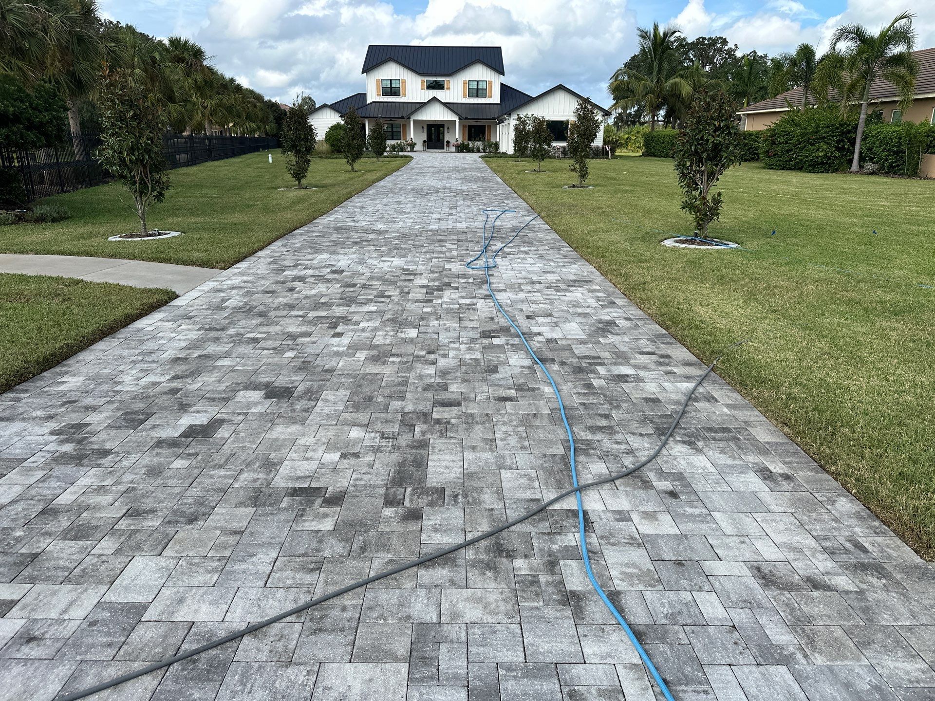 Complete Two-Story House Wash and Driveway Cleaning in Winding River Community, Bradenton, FL by Sunshine AquaWash
