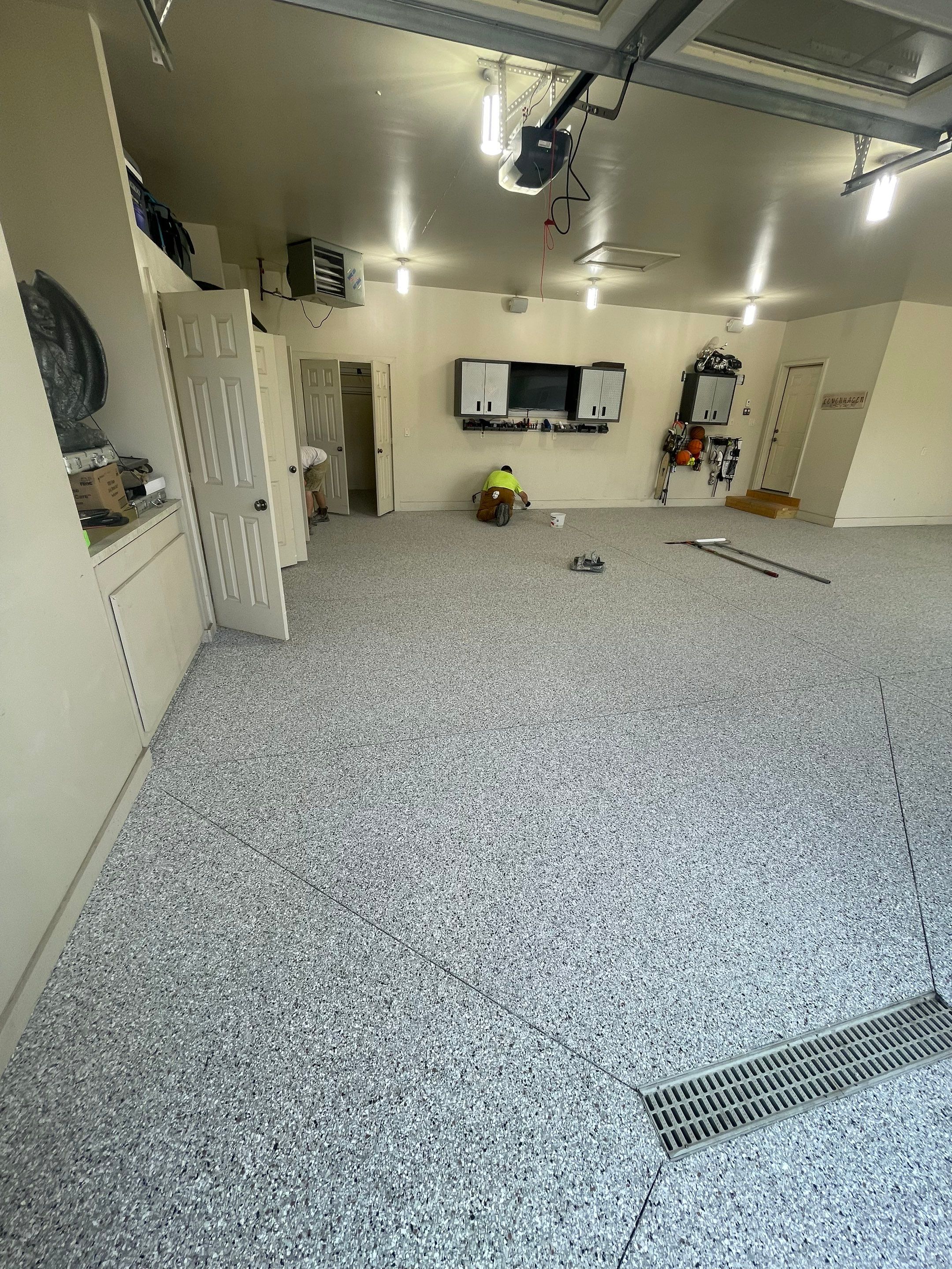 Coyote Flake Garage Floor Coating in Sioux Falls with Trench Drain by Select Painting, Coatings & Garage Cabinets