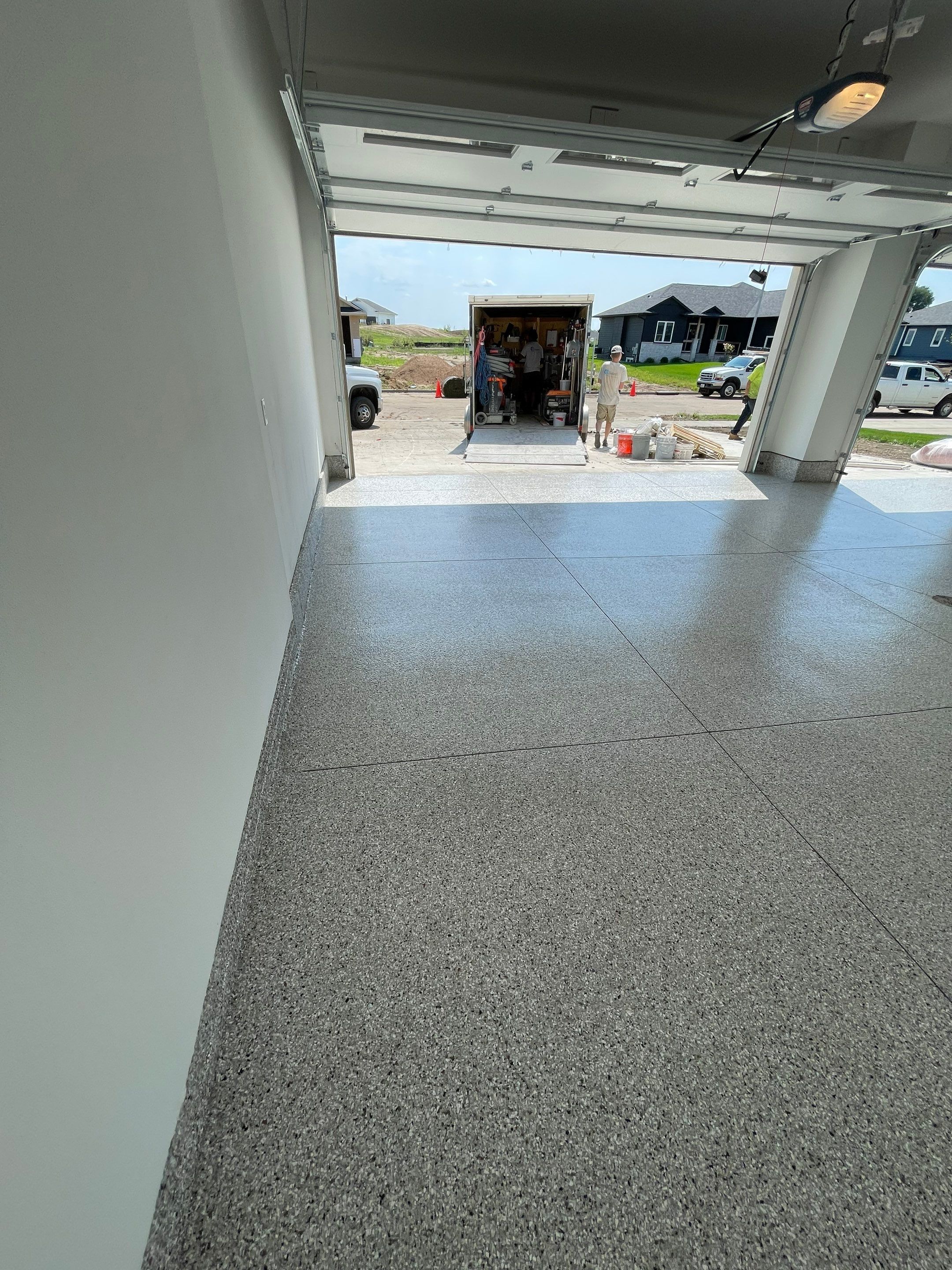 Grey Speckled Garage Floor Coating in Sioux Falls by Select Painting, Coatings & Garage Cabinets