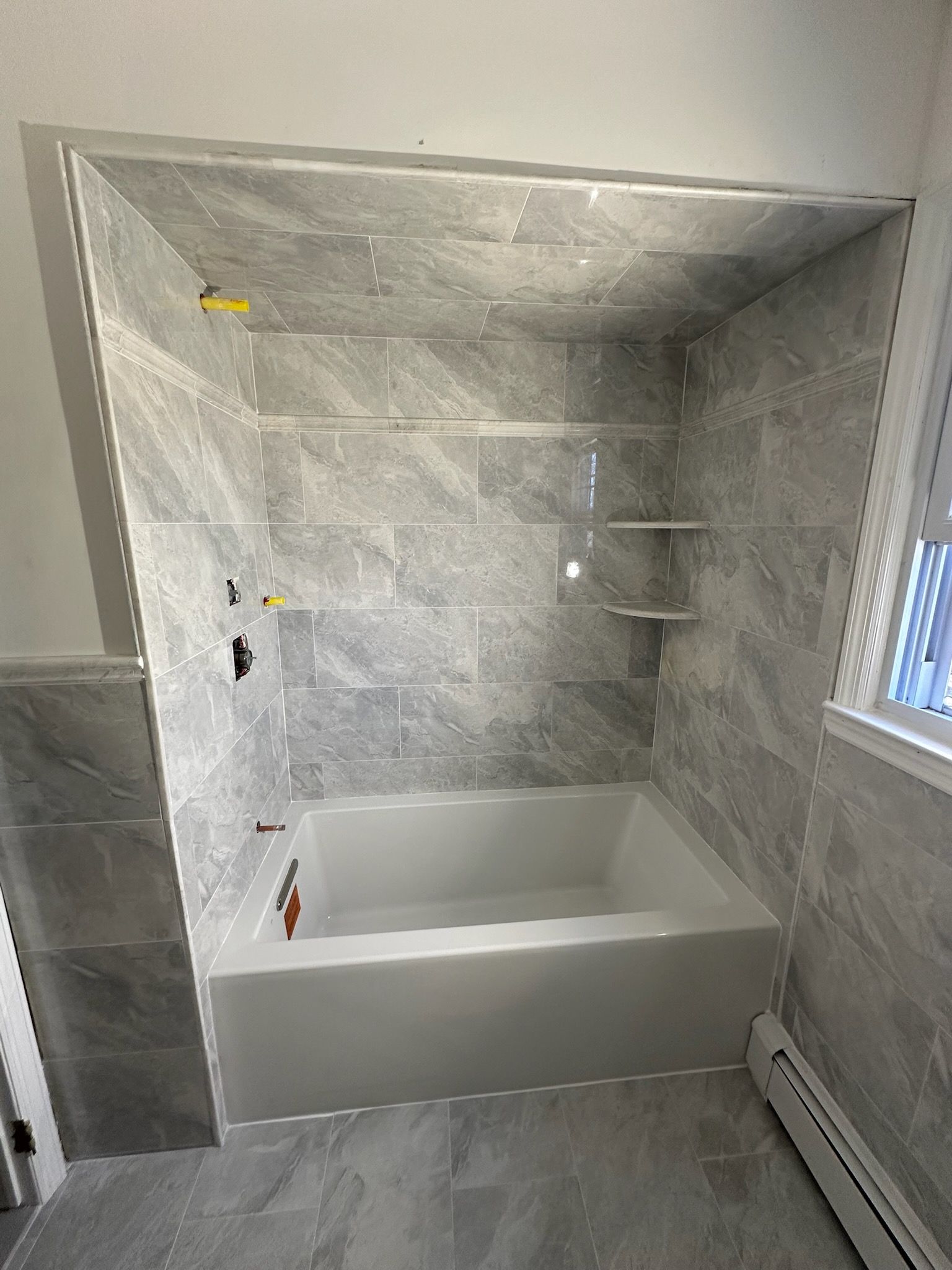 Bathroom Remodel using Porceline Tile from The Tile Shop by Footprints Floors Morristown
