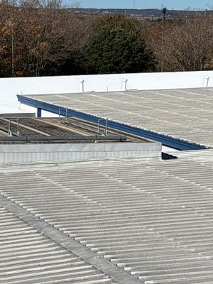 Metal roof section adjacent to flat roof membrane