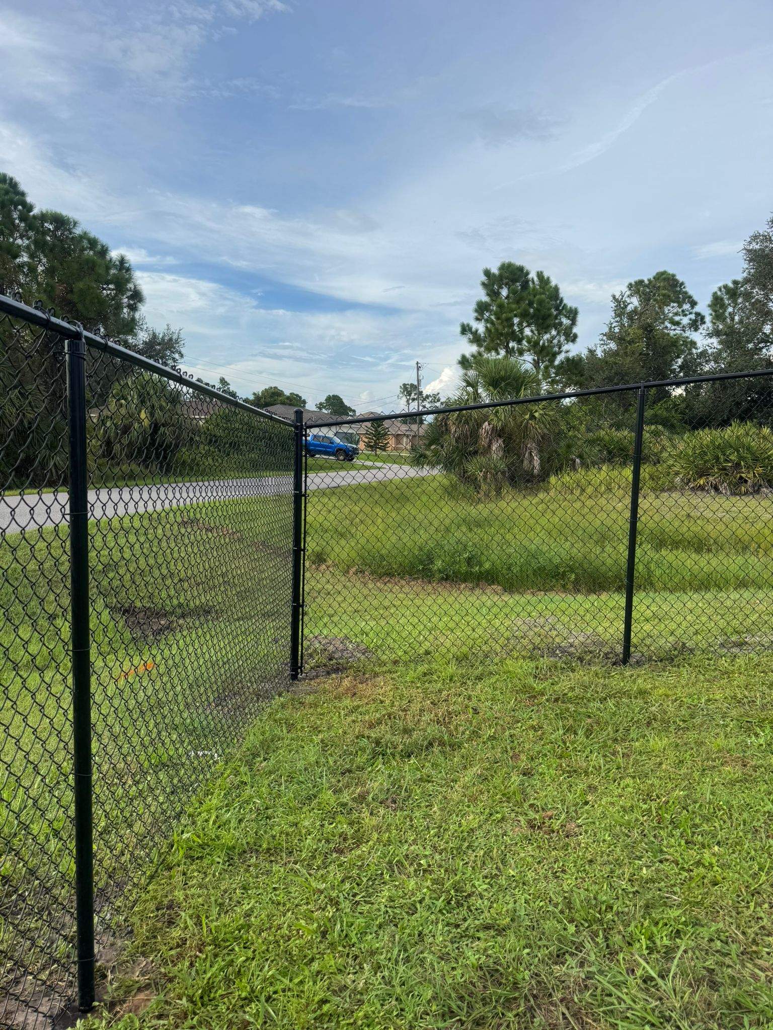 Black Vinyl-Coated Chain Link Fence and Gate Installation in North Port by True Fence LLC