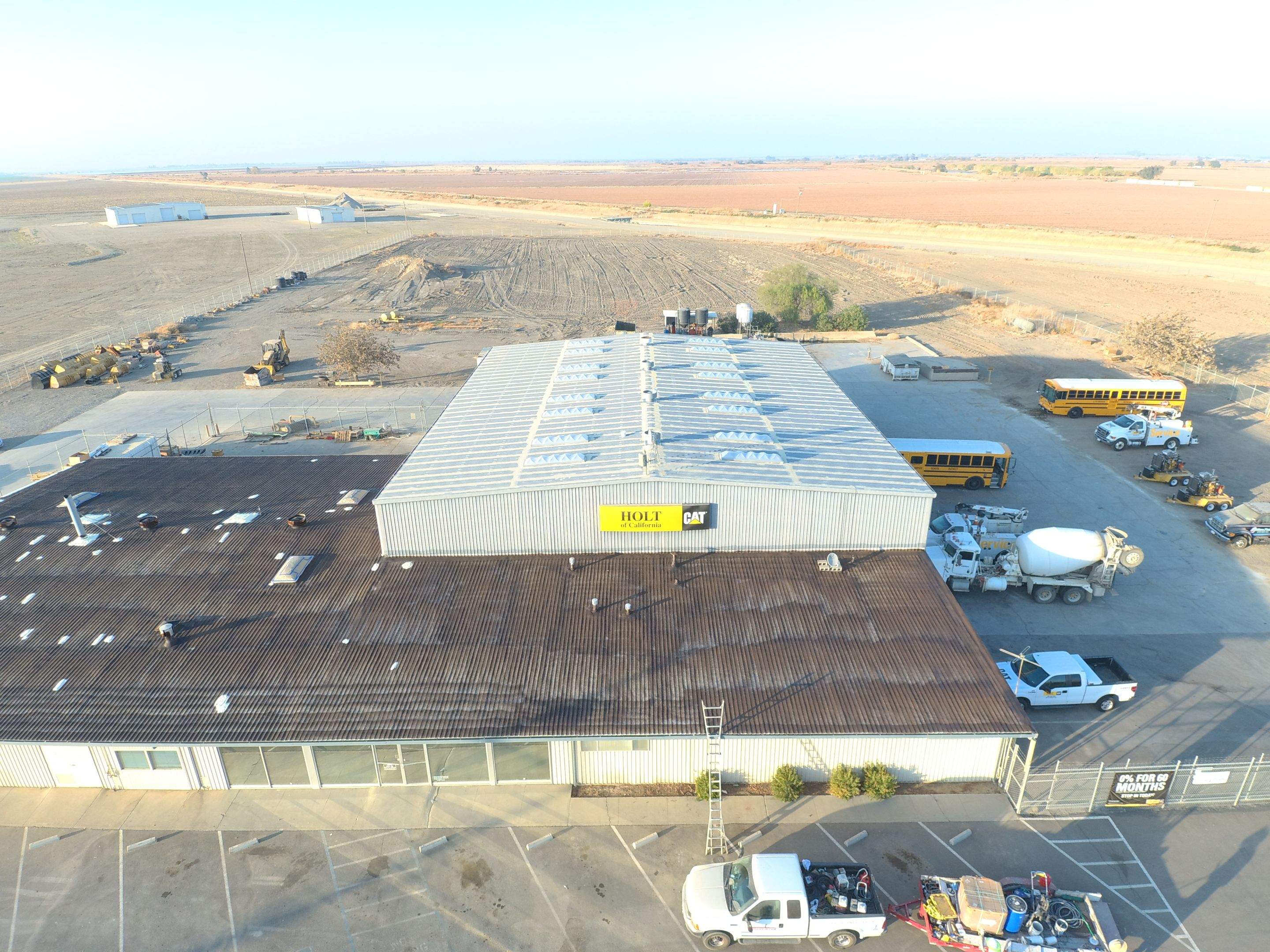 Metal roof restoration on commercial roof using Conklin Benchmark/ PUMA XL acrylic coatings over metal and foam by Straight Edge Roofing Inc