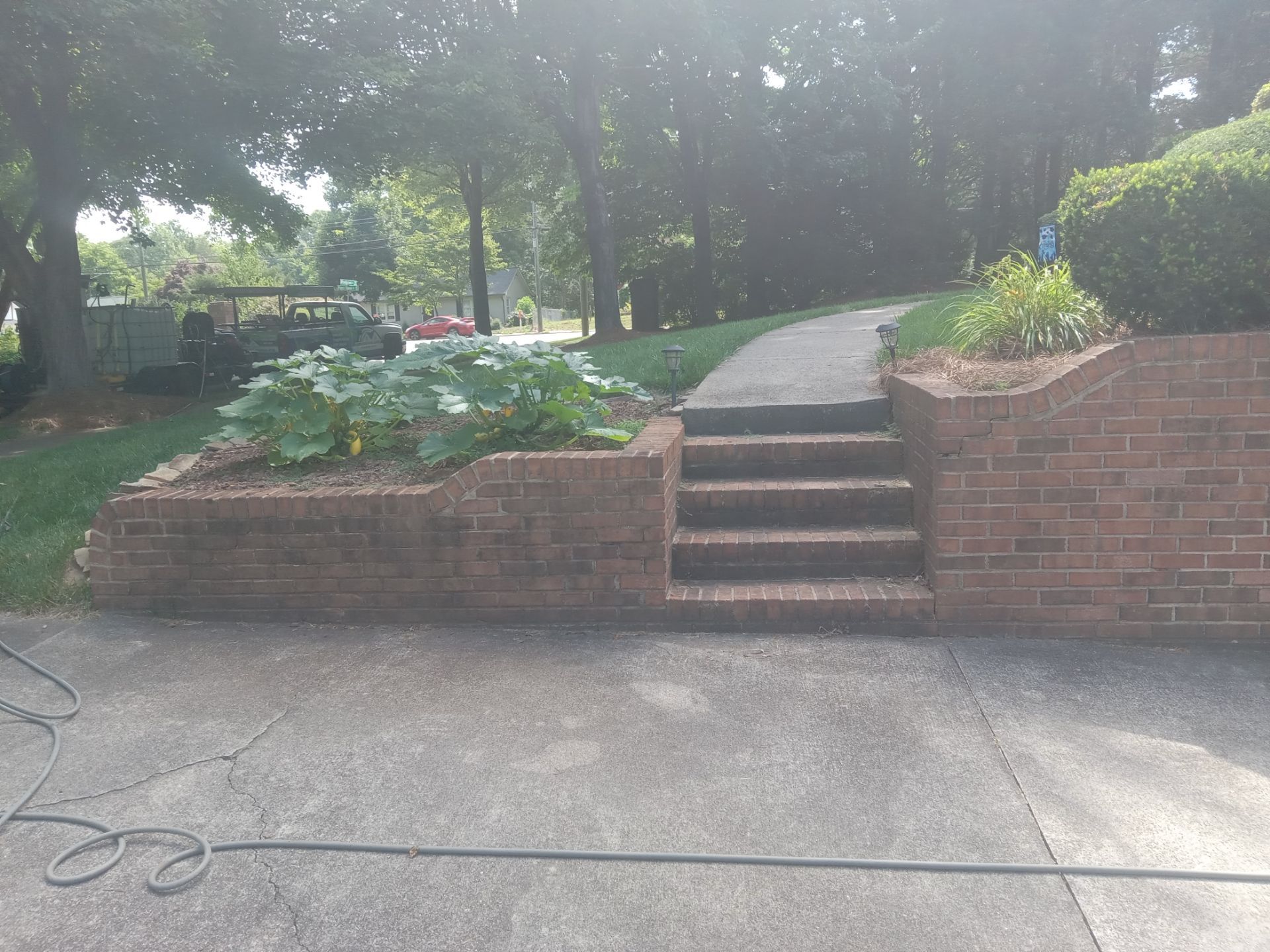 pressure washing concrete driveway and brick steps removing dirt mold mildew for clean refreshed appearance