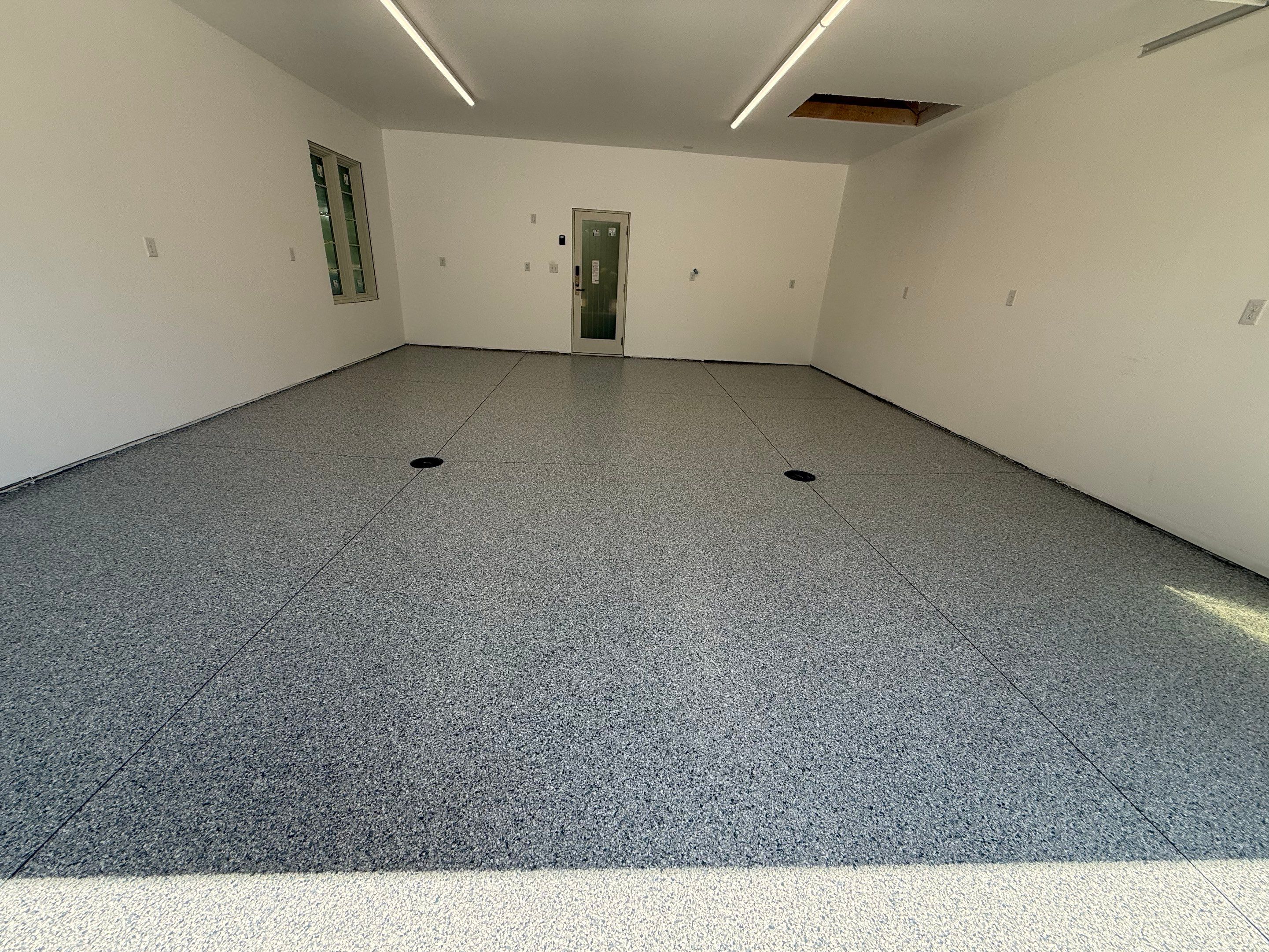 Multi-Car Garage Floor Coating Installation in Sioux Falls by Select Painting, Coatings & Garage Cabinets