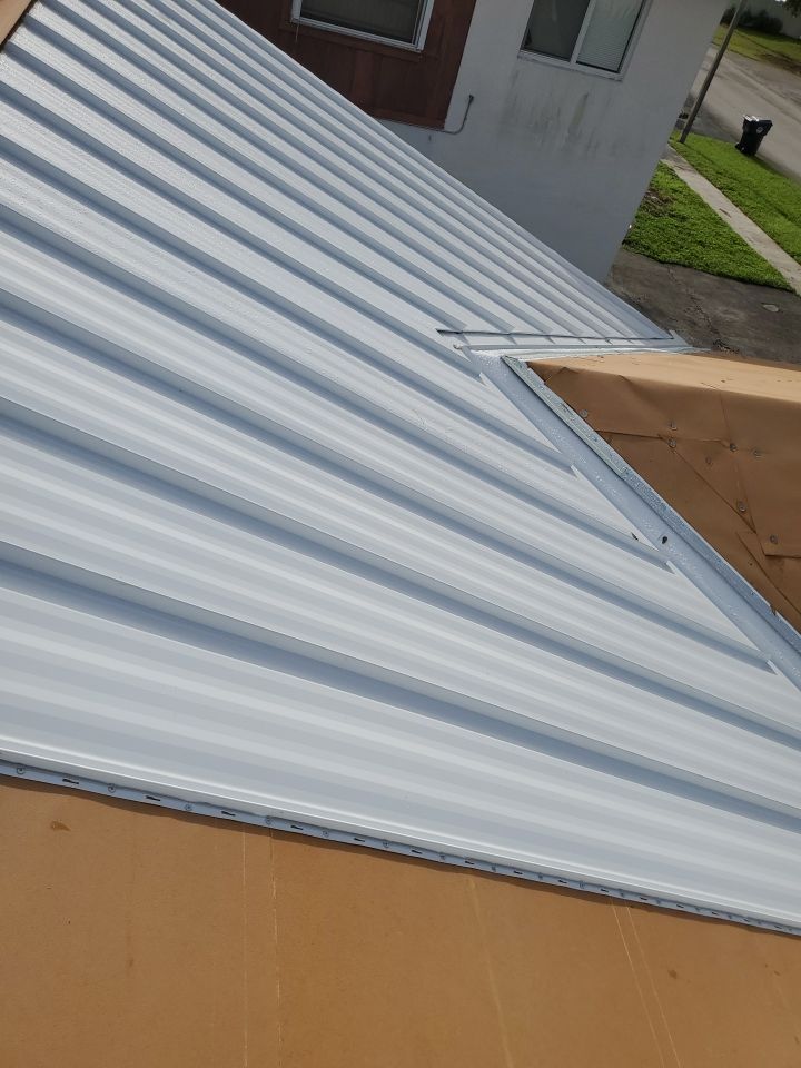 Residential Roofing Installation using 1.5" Nail Strip 24ga Solar White Kynar Coated Standing Seam Metal Panels by Morton Roofing, Inc.