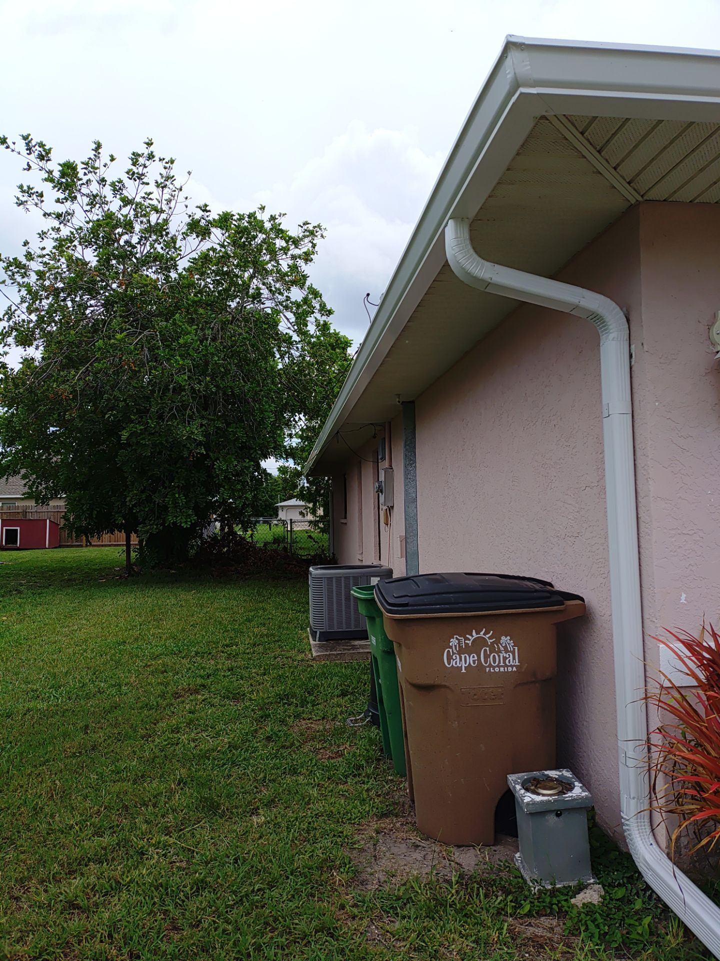 Replace gutter using White Down Spouts in Cape Coral FL by Gutter Professors