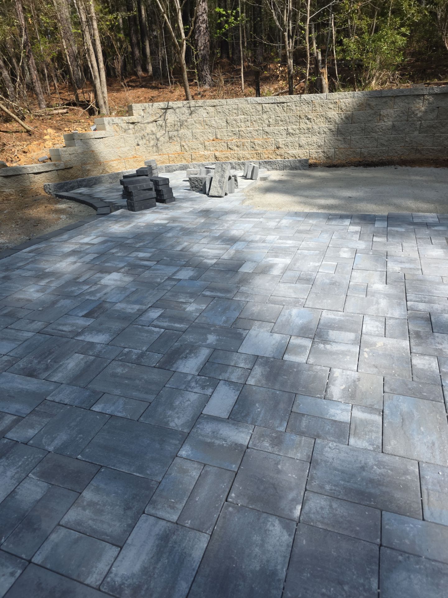 Pittsboro Outdoor Living Transformation – Retaining Wall, Paver Patio & Elevated Deck by Elite Remodeling and Design LLC