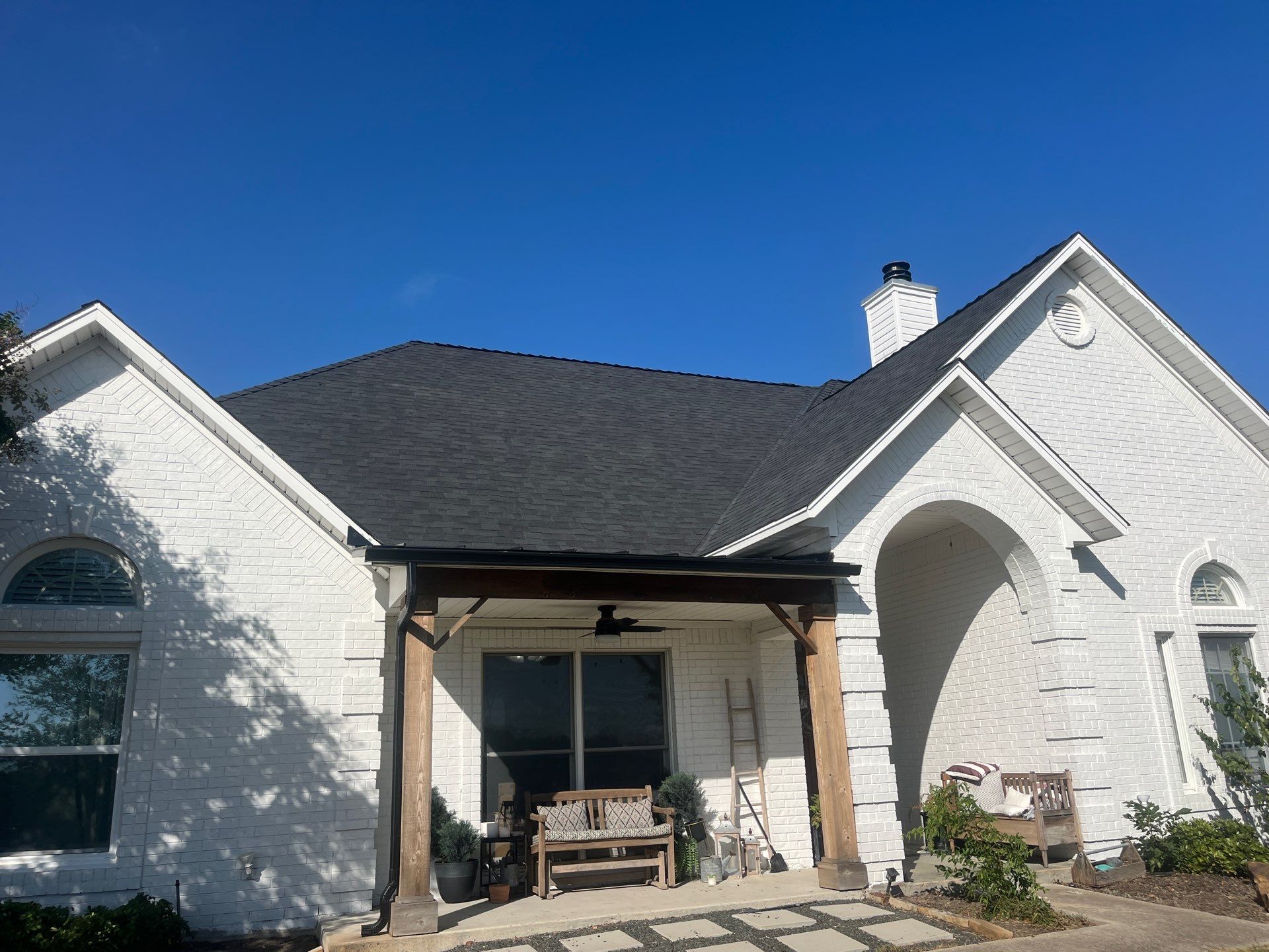 White brick with Malarkey Brilliant Black by Tejas Roofworks + Restoration