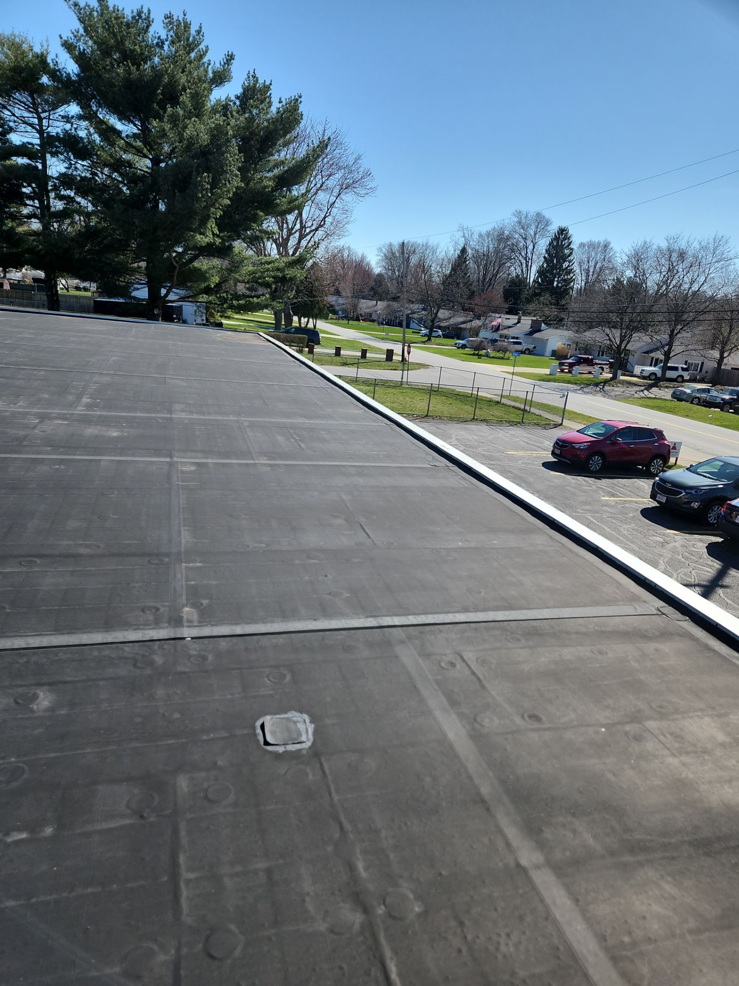 Commercial Roofing Repair using UniFlex Silicone Roof Coating on KinderCare Learning Center by 3 Daughters Construction 