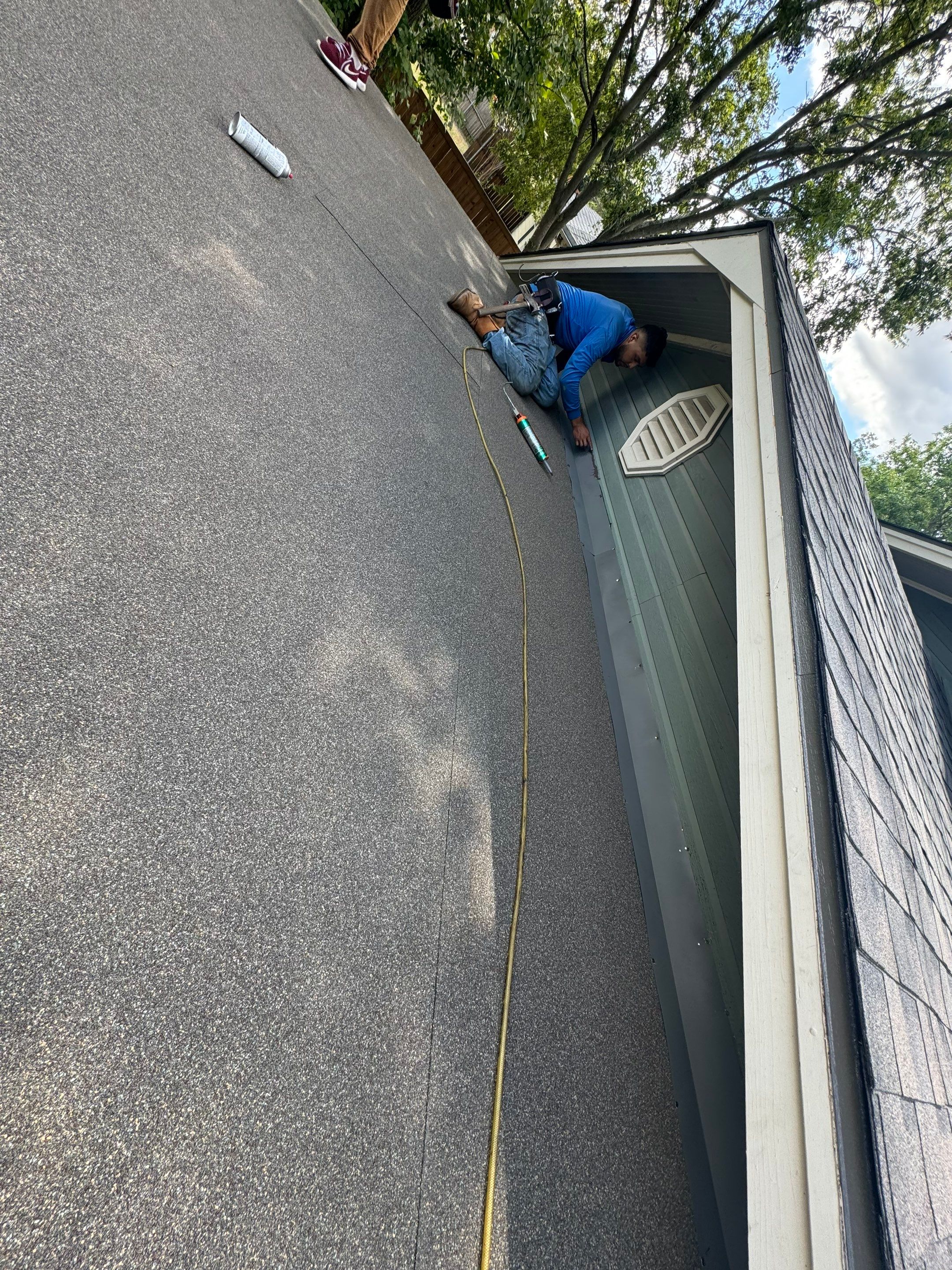 IKO Driftshake-Dark green siding house by Tejas Roofworks + Restoration