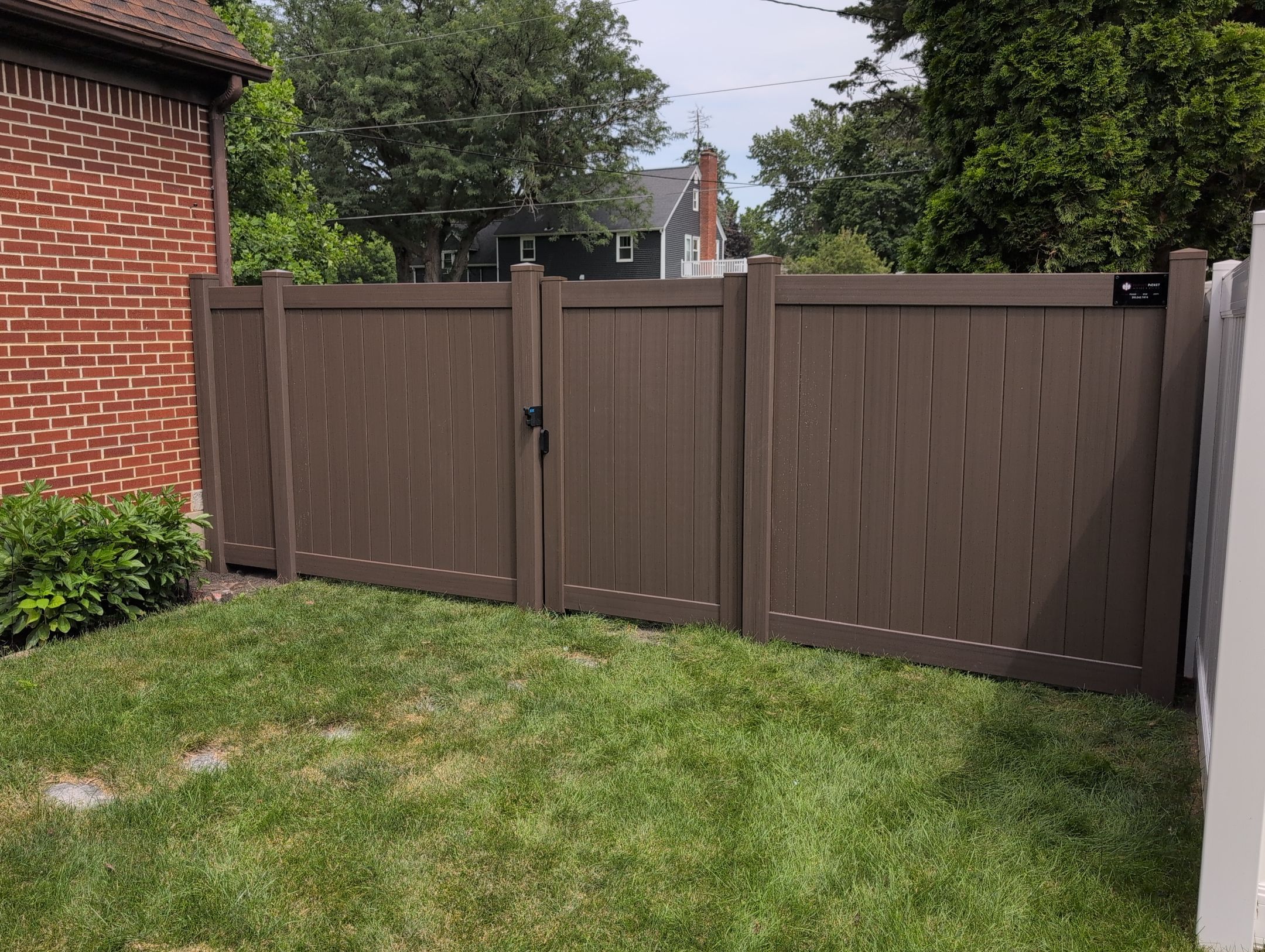Walnut Vinyl Privacy Fence Installation in Waterloo by Perfect Picket Fence and Stain
