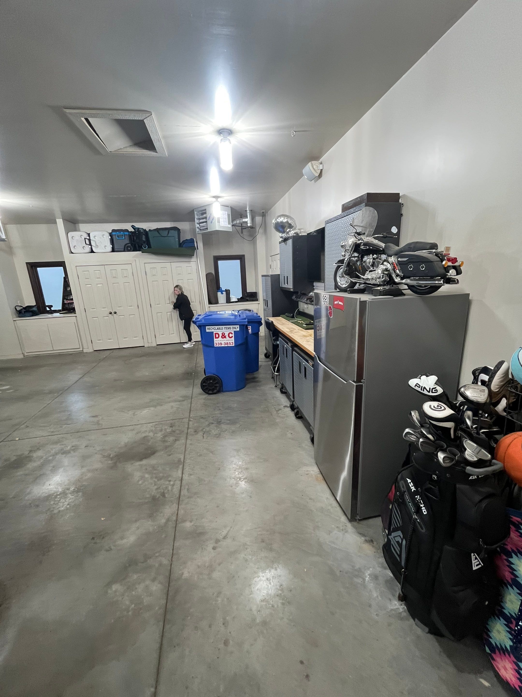 Coyote Flake Garage Floor Coating in Sioux Falls with Trench Drain by Select Painting, Coatings & Garage Cabinets