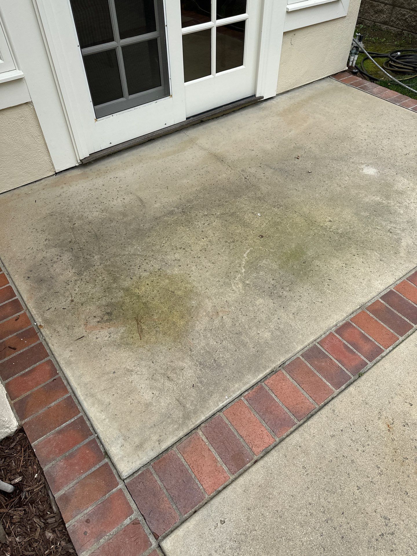 Surface cleaning pressure washing in Orange County on patio, walkways, and driveway by Property Cleaning Experts, LLC