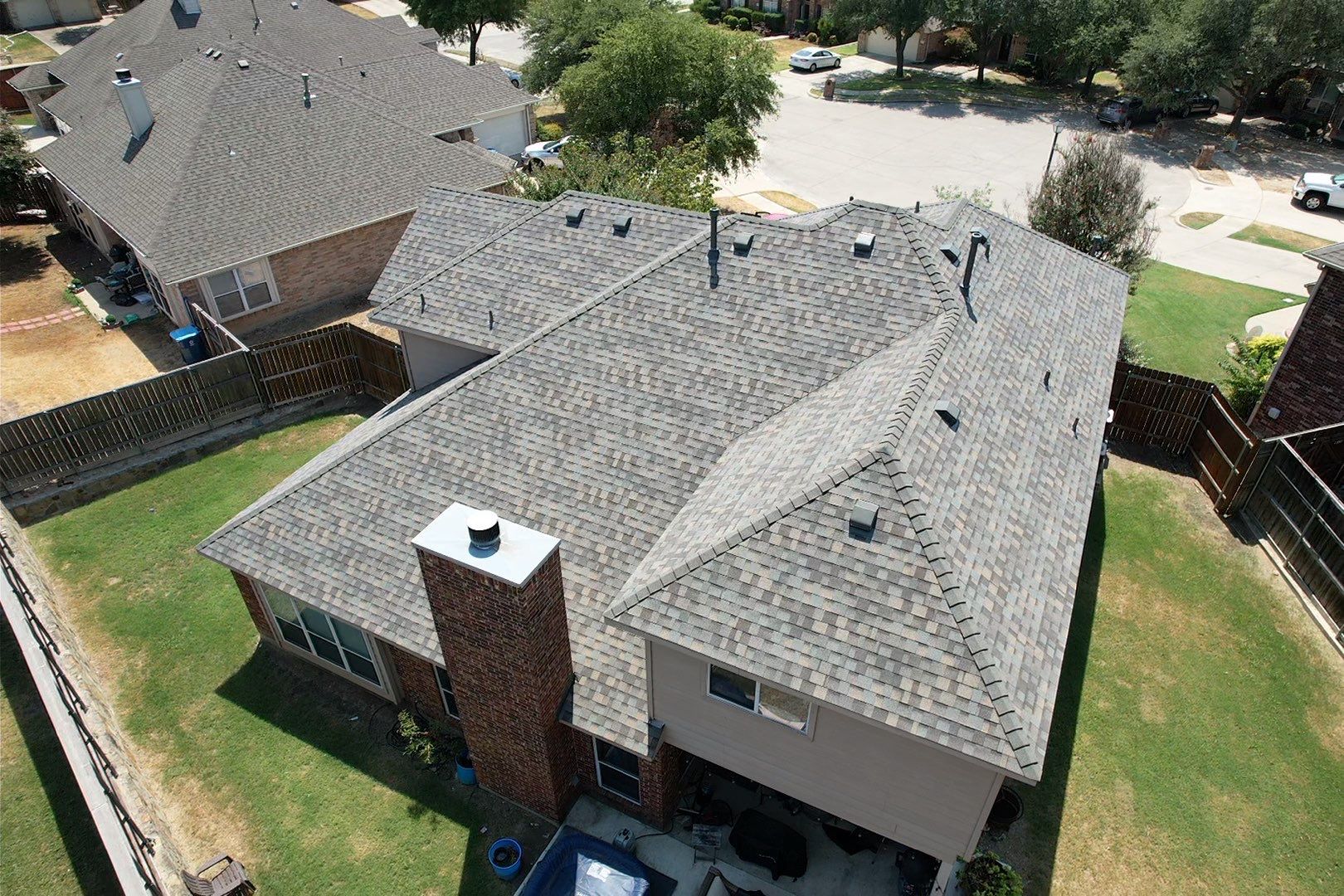 Red brick/white stone with IKO Cornerstone by Tejas Roofworks + Restoration
