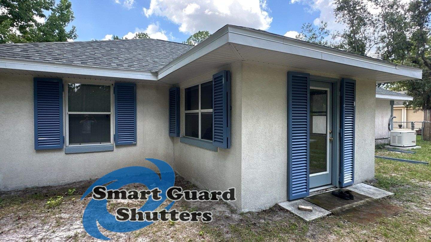 Impact Rated Colonial Shutters in Pigeon Blue by Smart Guard Shutters