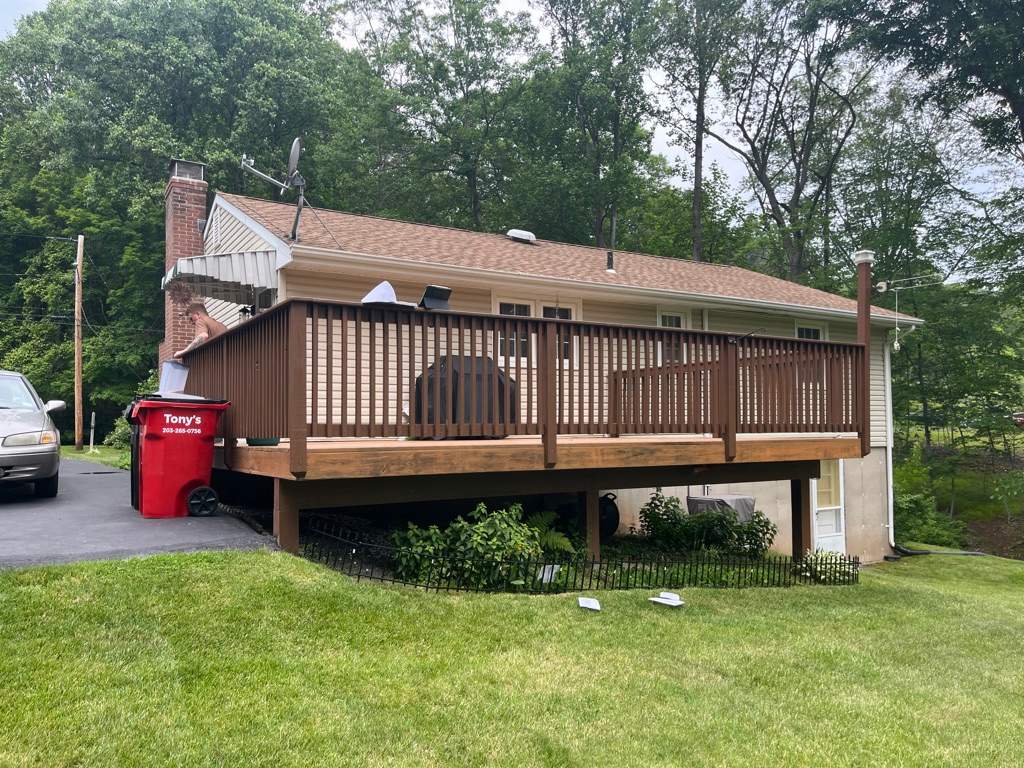 Replacement Deck, Trex Tropical Tiki torch , Matching Fascia. Black Transcend railing and Lattice. by DiGiorgi Roofing and Siding Inc