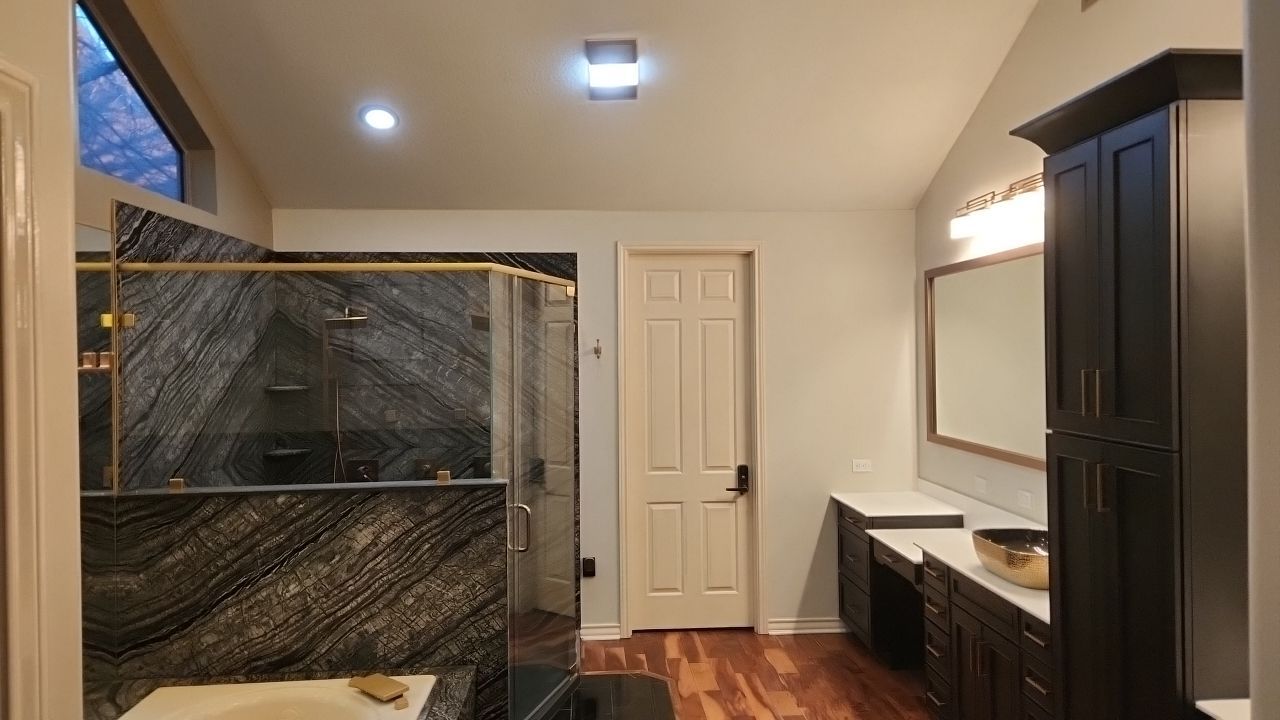 Bookmatched Natural Stone Shower by Legacy Bath and Kitchen 