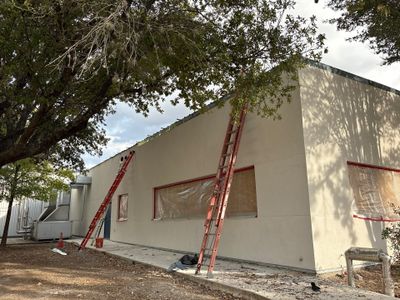 Exterior view of building with metal roof and ladders
