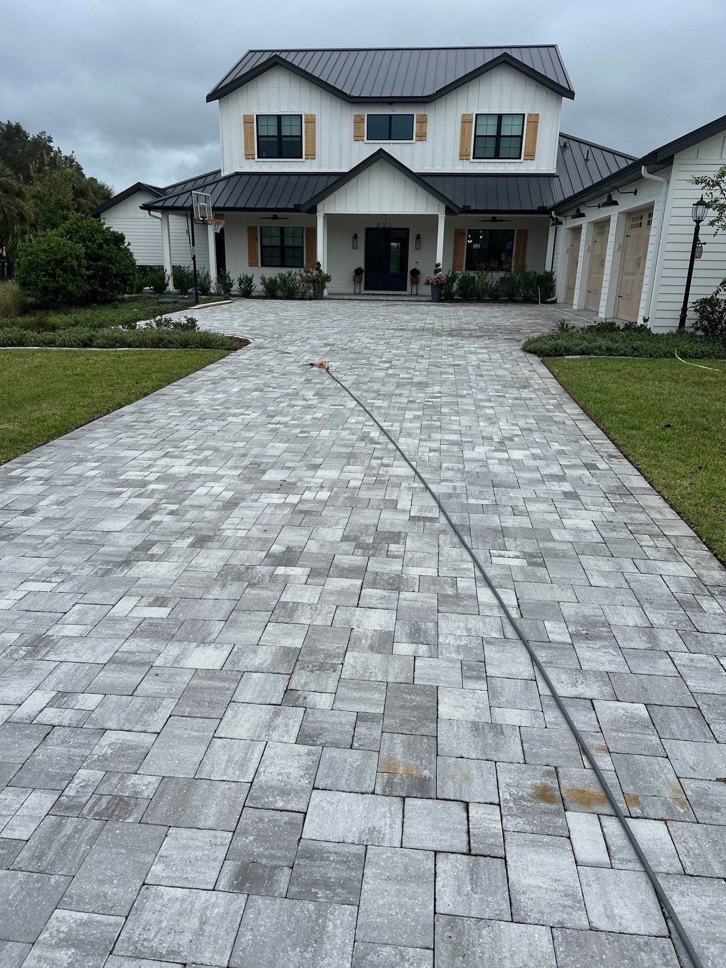Complete Two-Story House Wash and Driveway Cleaning in Winding River Community, Bradenton, FL by Sunshine AquaWash