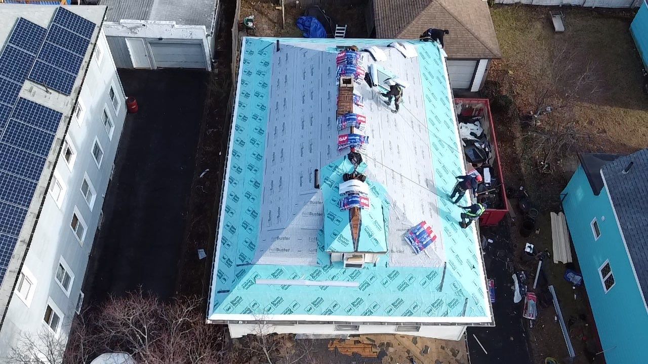 Roof Installation Roof Type: Hip Roof  Multi Family Home- 2 Story by Delarosa Construction & Design