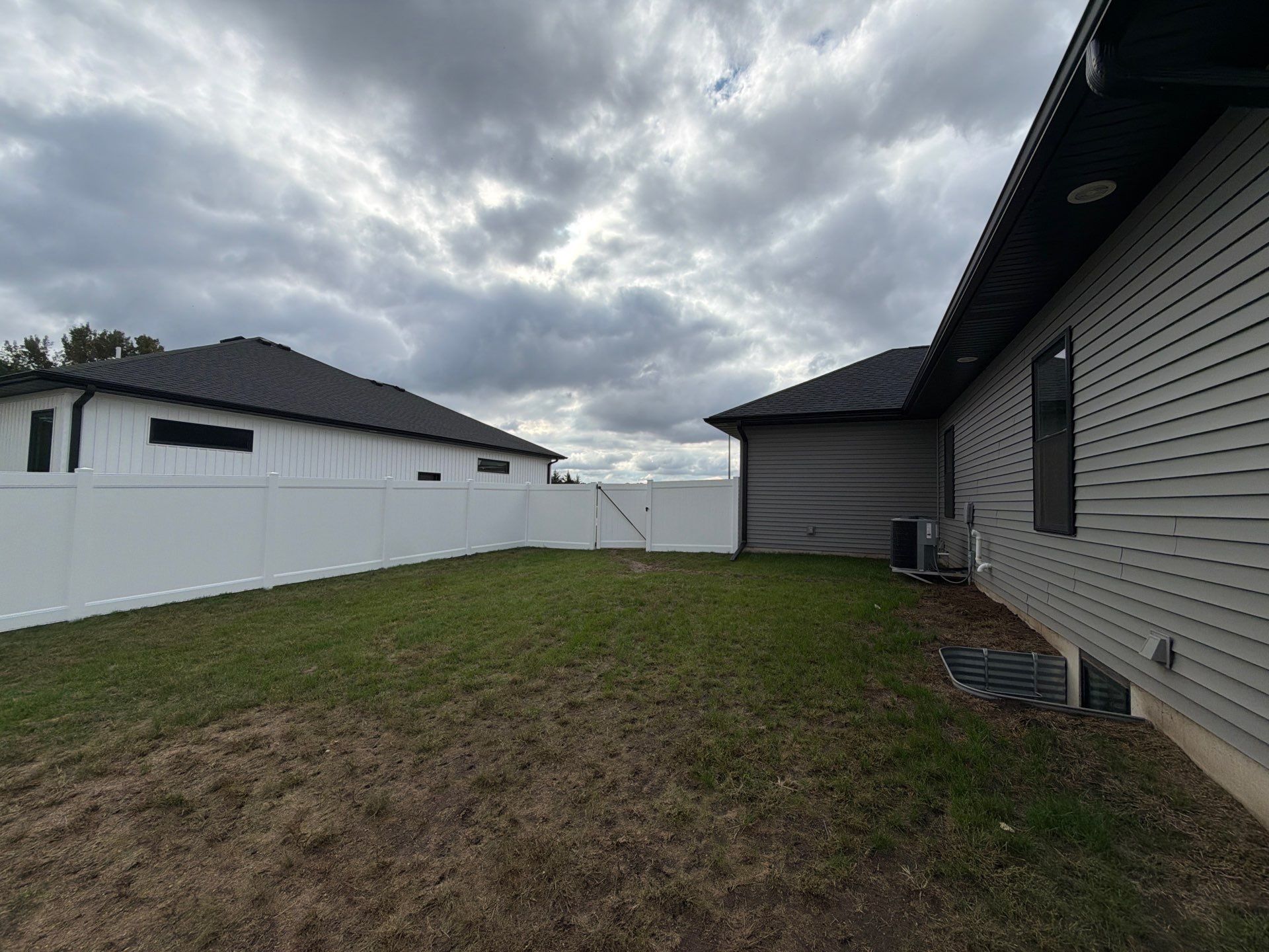 Residential White Vinyl Privacy Fence Installation in Janesville by Perfect Picket Fence and Stain