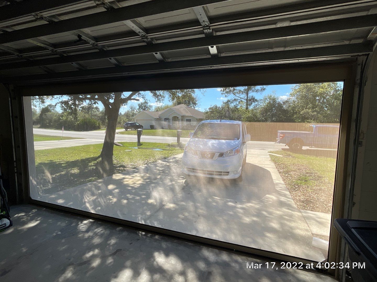 Garage motorized rolling screen by Smart Guard Shutters