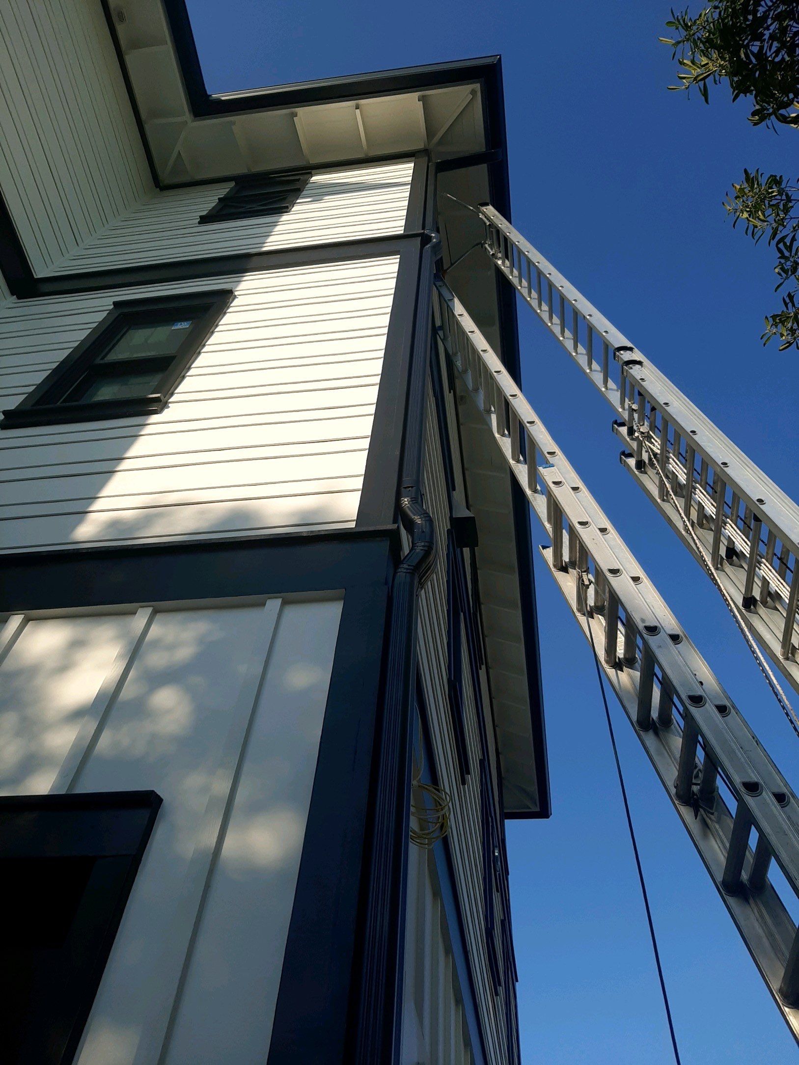 Seamless Gutter Installation Using Black Half Round Seamless Gutters by Gutter Professors