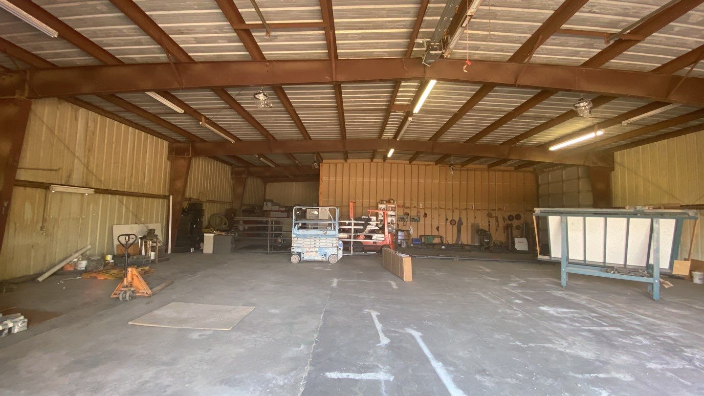 Spray foam insulation on inside of metal industrial building by Straight Edge Roofing Inc