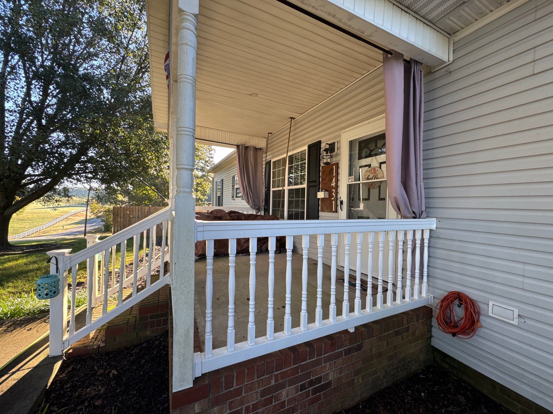 the service shown is cleaning the porch railing and siding using pressure washing techniques for thorough dirt removal and restoration