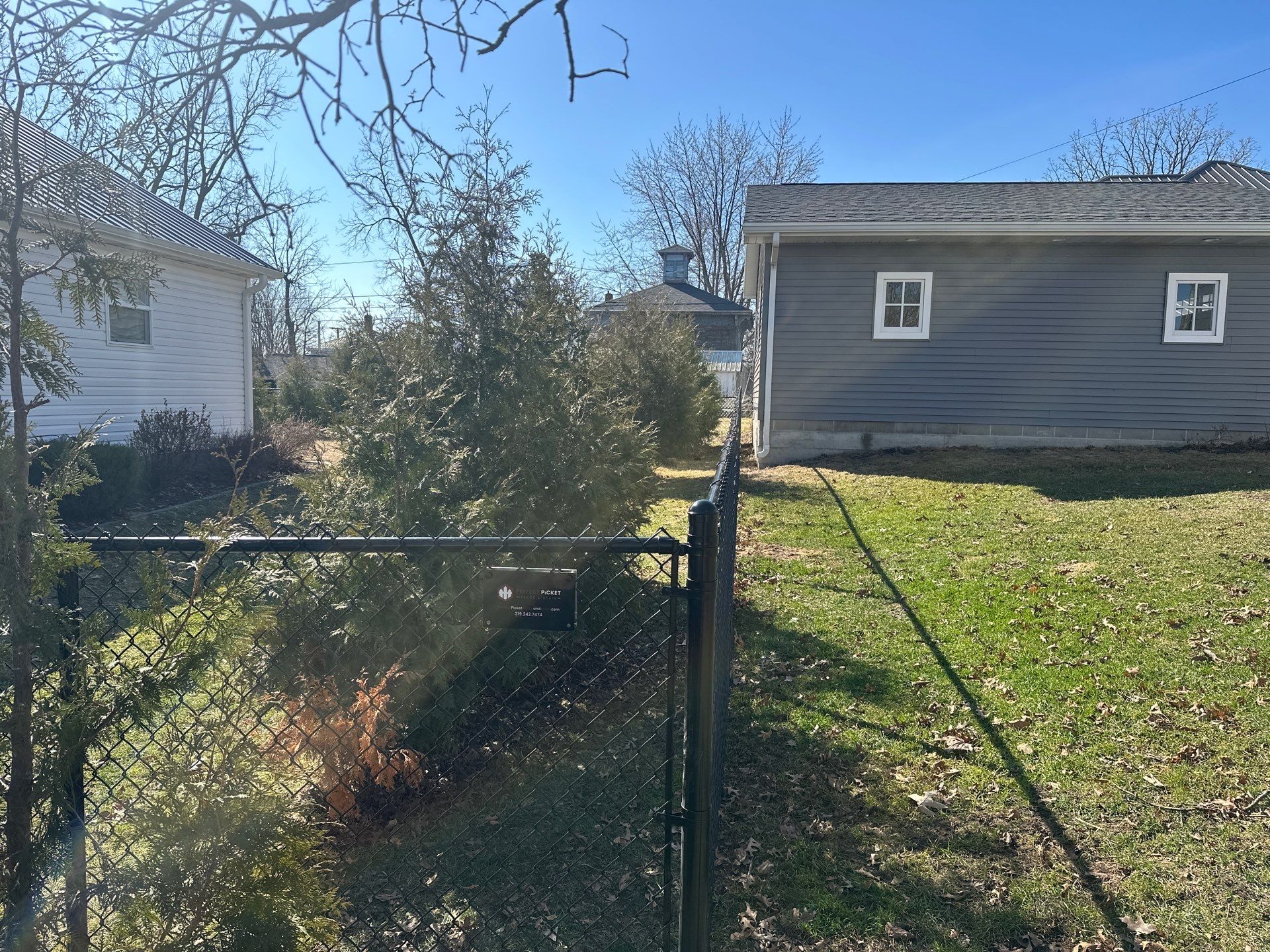 Black Chain Link Backyard Fence Installation in Independence by Perfect Picket Fence and Stain