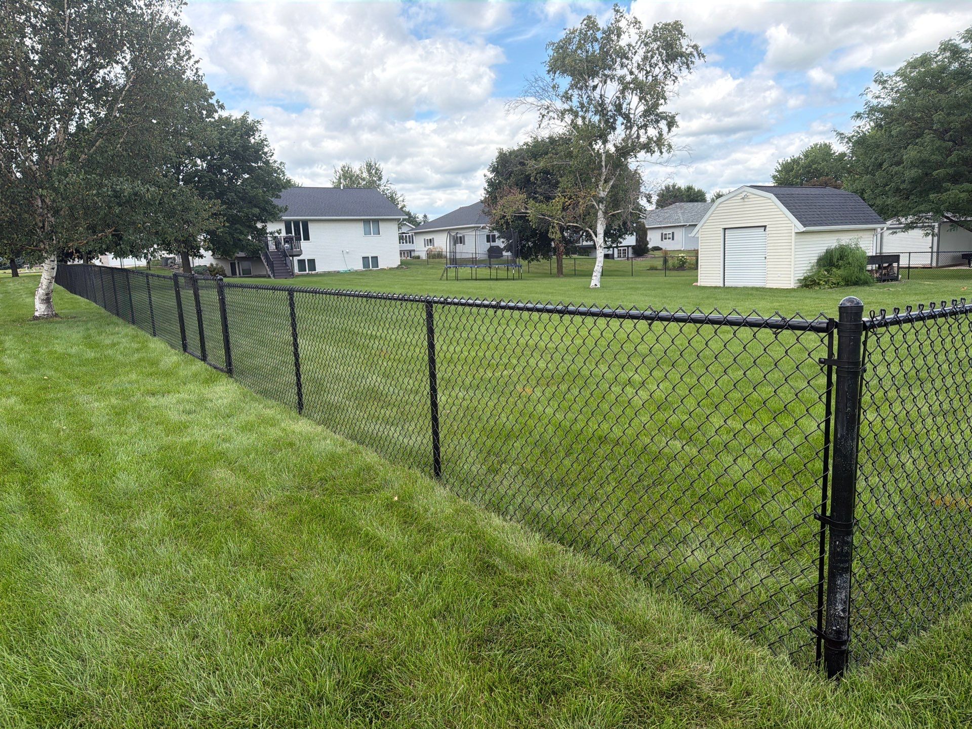 Black Vinyl-Coated Chain Link Fence Installation in Fairbank by Perfect Picket Fence and Stain