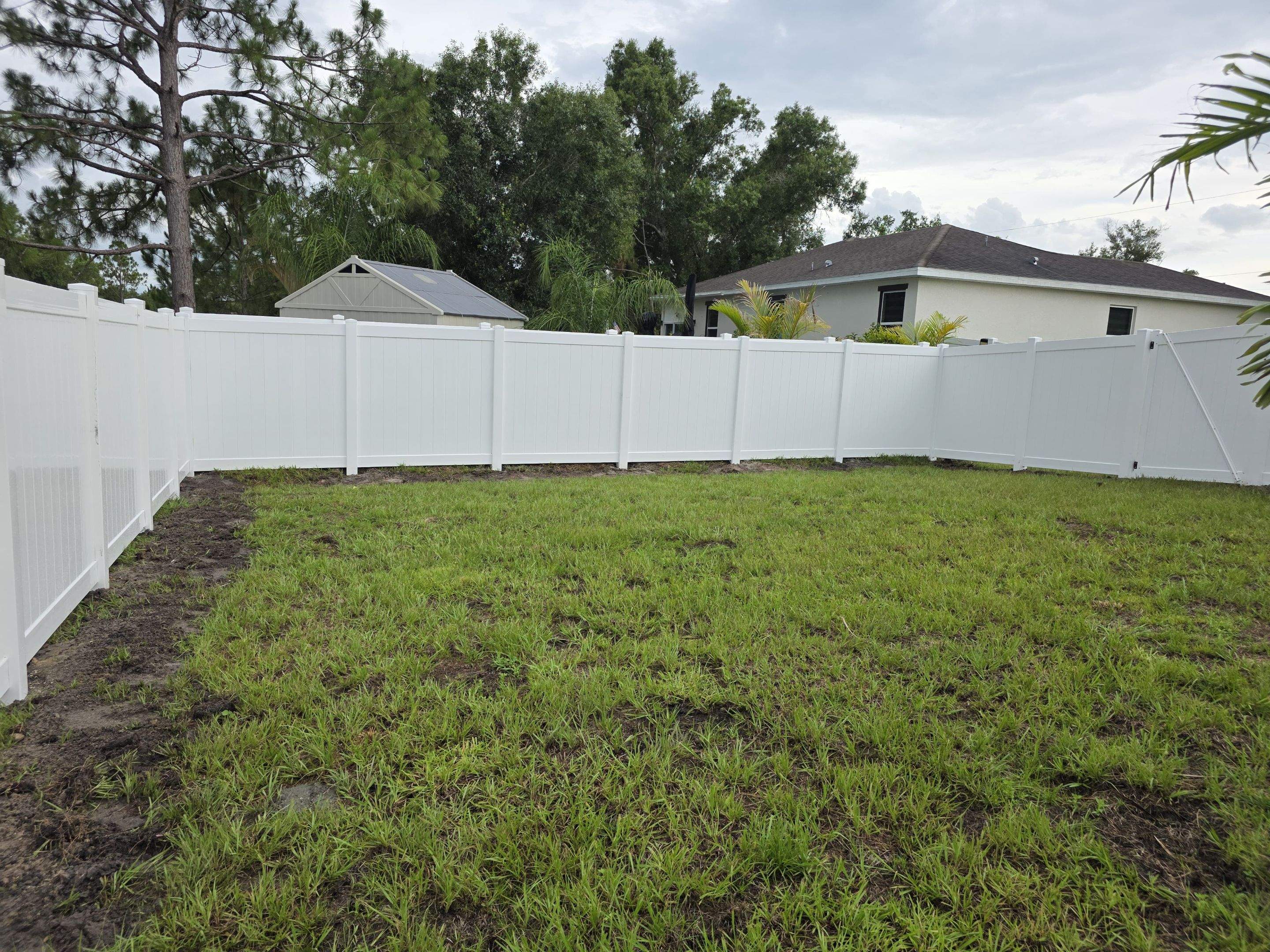 White Vinyl Privacy Fence with Gate Installation in North Port by True Fence LLC