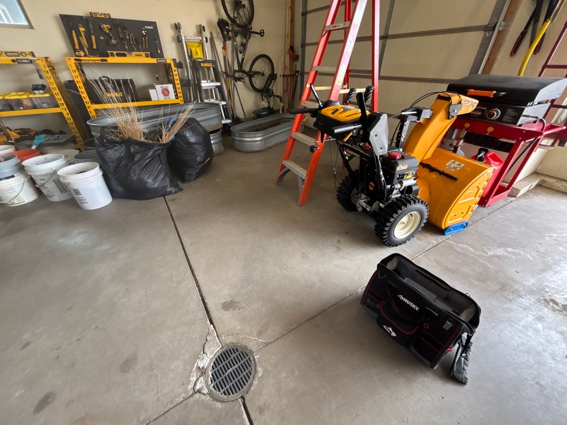 Sioux Falls Garage Floor Repair and Speckled Epoxy Coating Installation by Select Painting, Coatings & Garage Cabinets