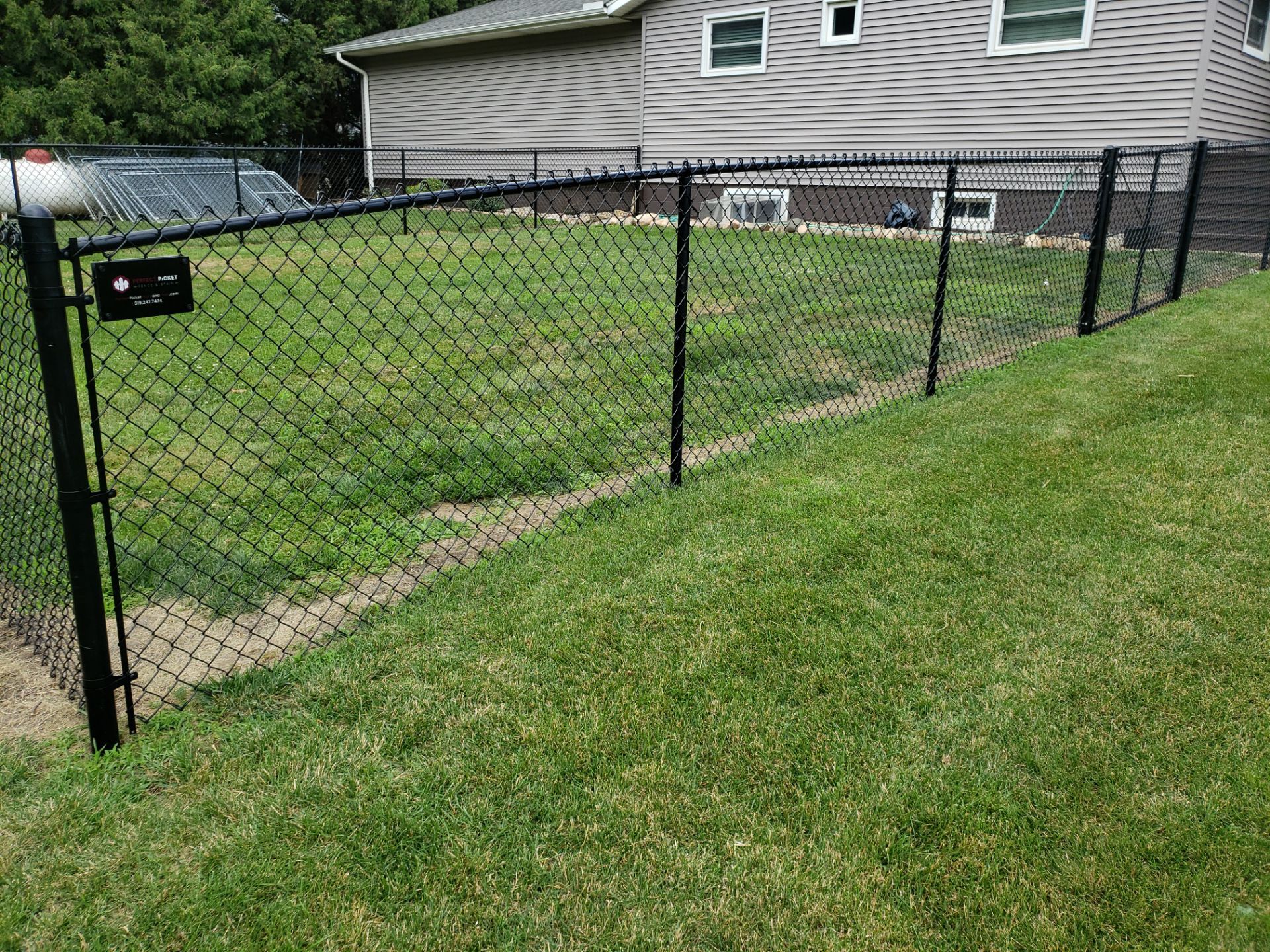 Black Vinyl-Coated Chain Link Fence Installation in Fredericksburg by Perfect Picket Fence and Stain