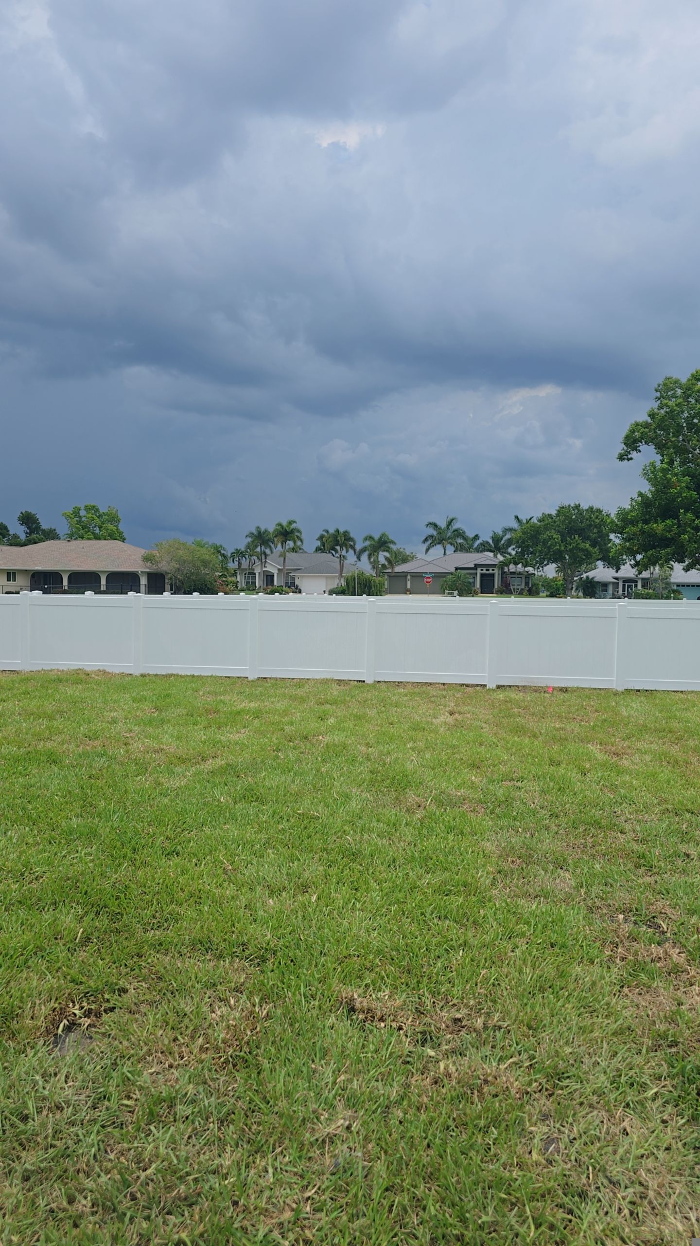 White Vinyl Privacy Fence Installation on Port Charlotte Corner Lot by True Fence LLC