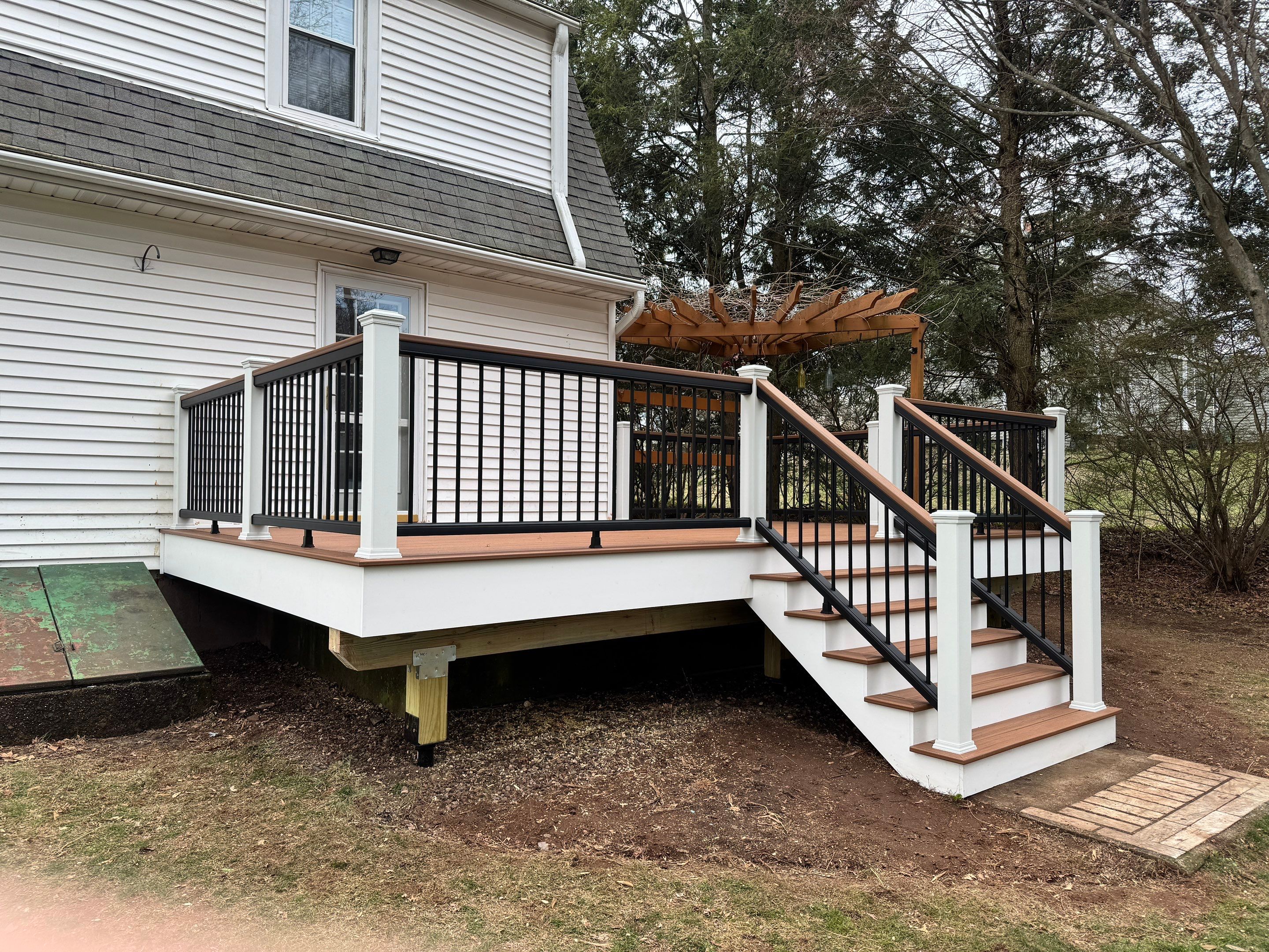 Replacement deck with Trex Transcend Tiki Torch deck boards and matching cocktail rail. by DiGiorgi Roofing and Siding Inc