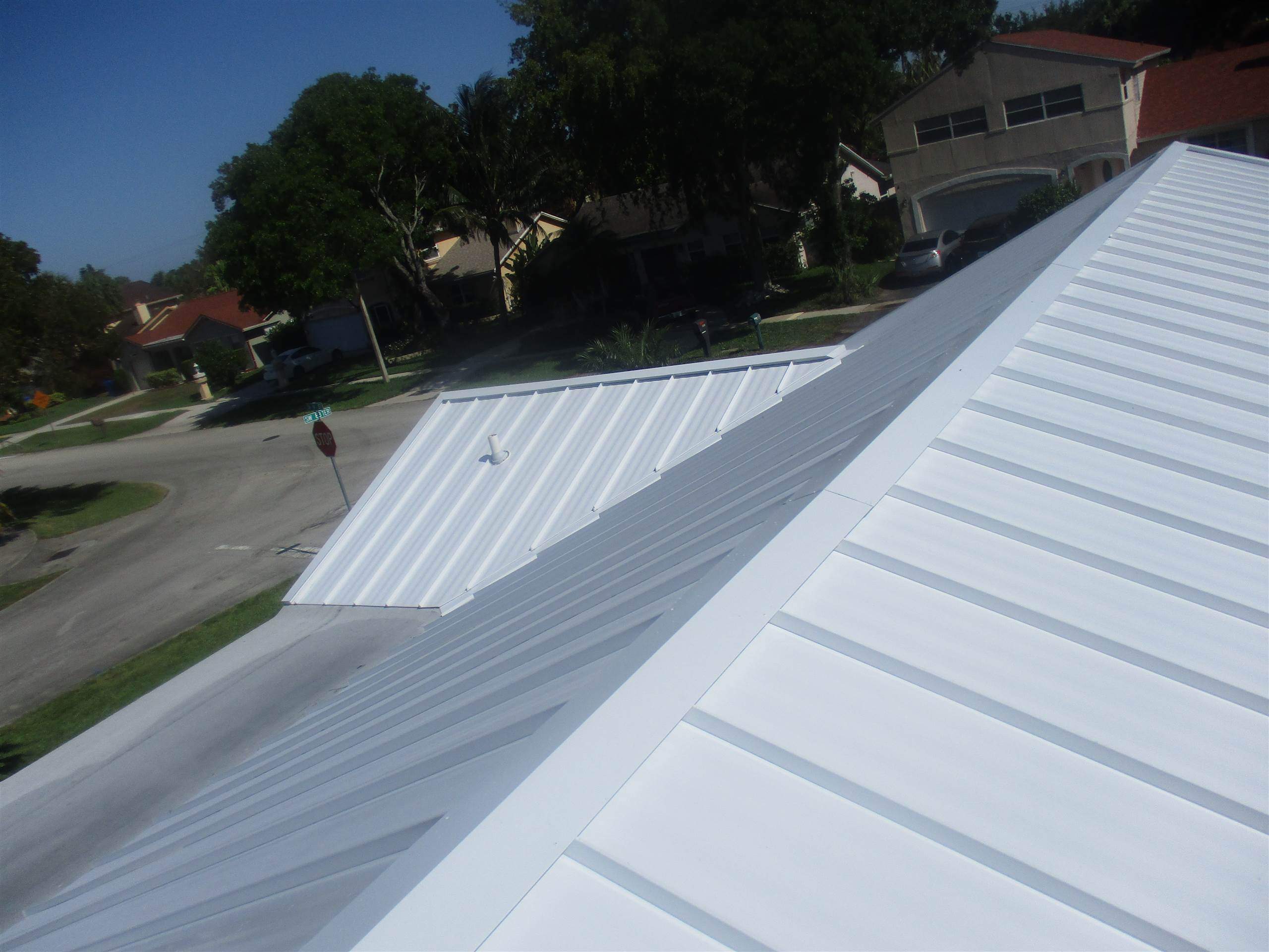 Standing Seam Metal & Flat Re-Roof using 1.5" Nail Strip 24ga Solar White Kynar Coated Standing Seam Metal Panels by Morton Roofing, Inc.