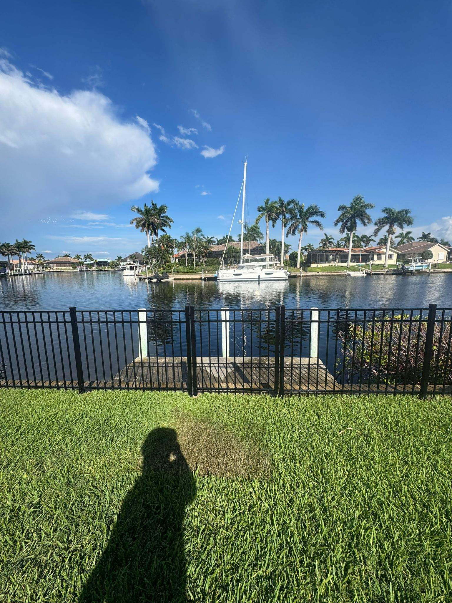 Black Aluminum Fence Installation Along Punta Gorda Canal by True Fence LLC