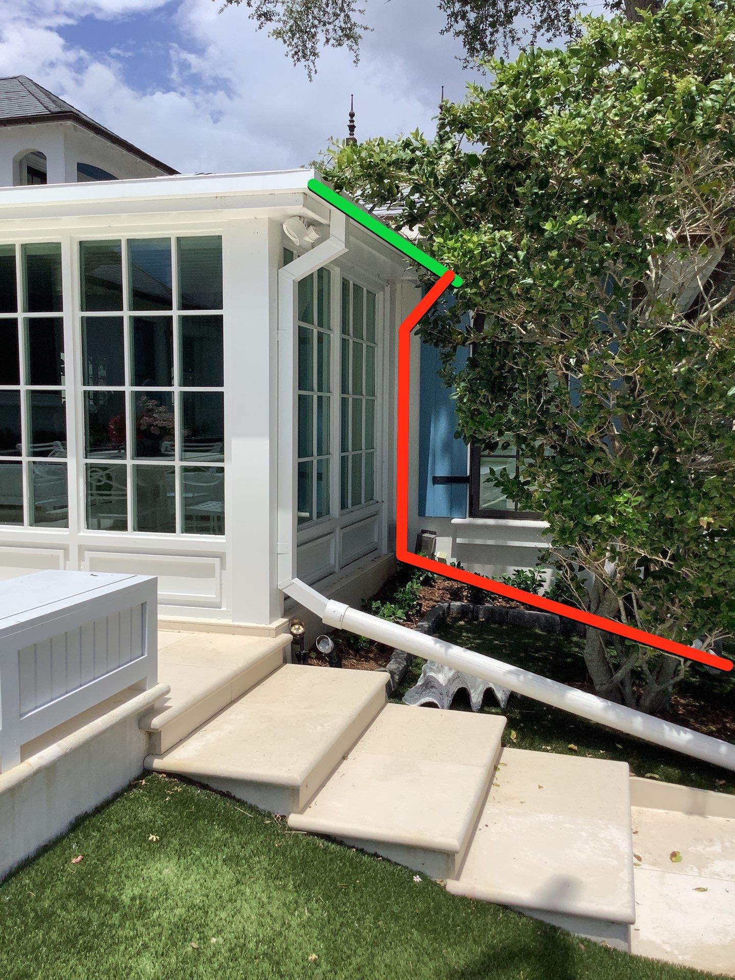 Seamless aluminum gutter installation in Sarasota, FL using 3x4 elbow downspouts combined with round downspouts by Gutter Professors